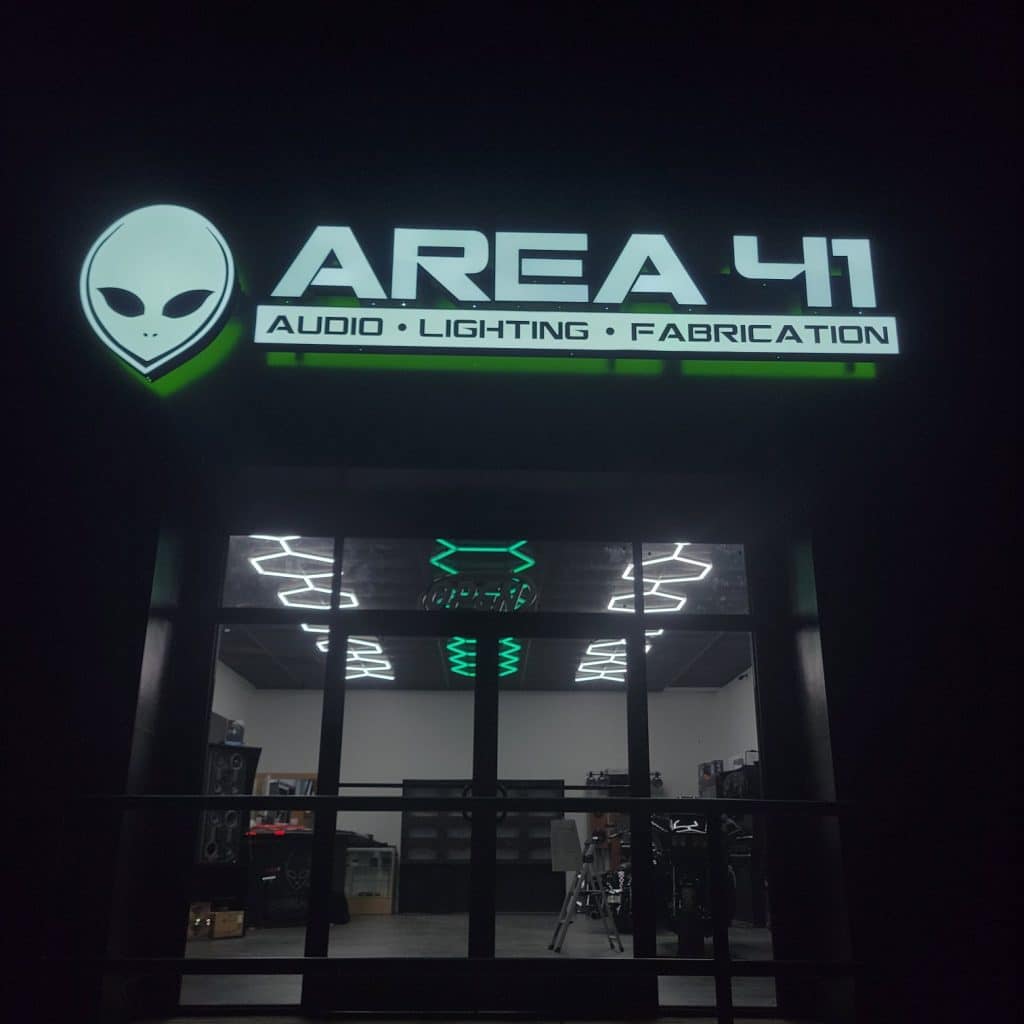 Illuminated storefront sign at night, Area 41, Kennesaw, GA, by High Stakes Creative