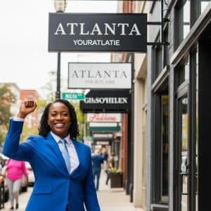 Business owner in Atlanta proudly displaying a new sign in front of their store, symbolizing success and compliance with local regulations