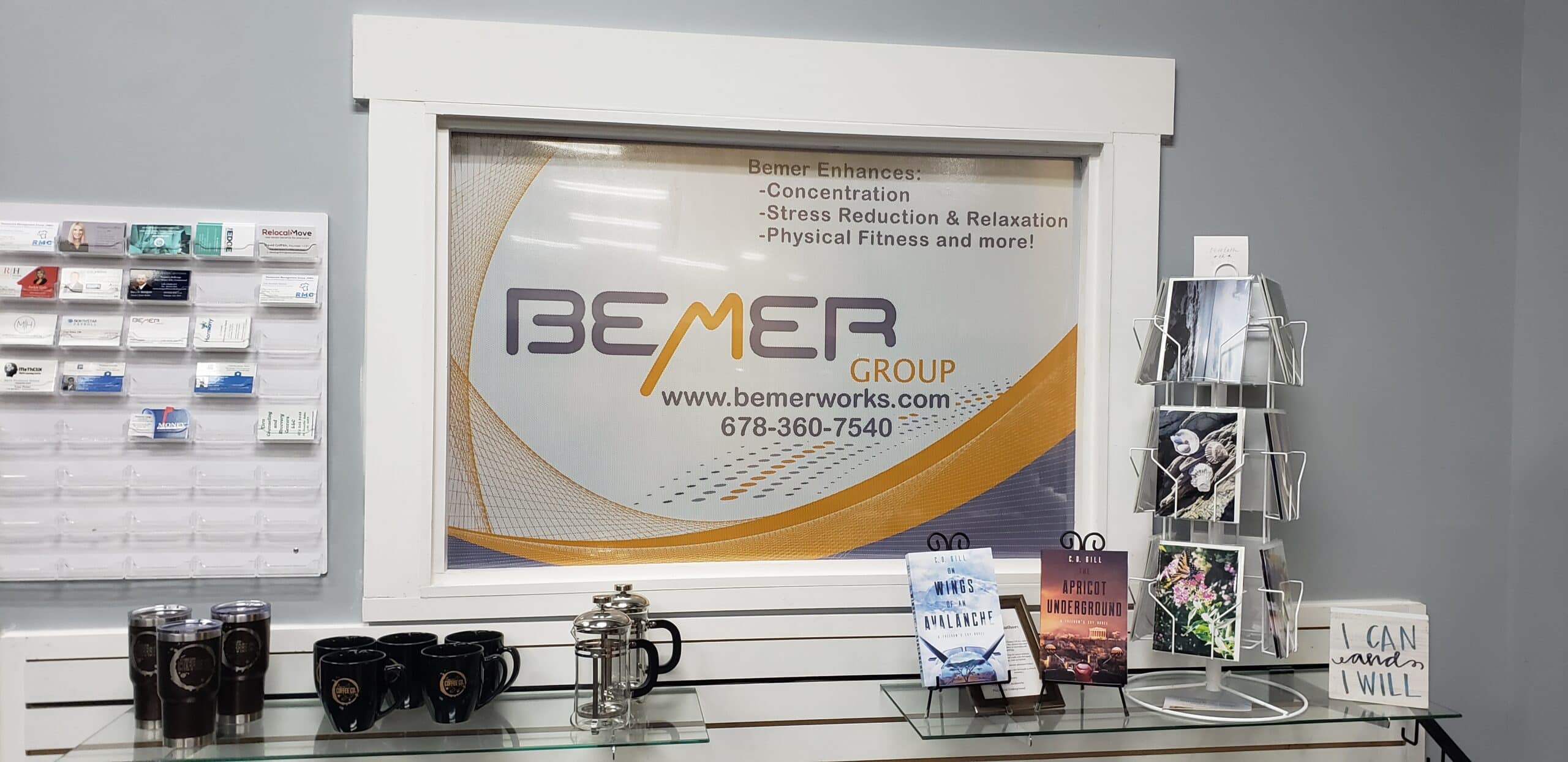 Framed printed wall graphic with BEMER Group logo and benefits list above a retail display, BEMER Group, by High Stakes Creative