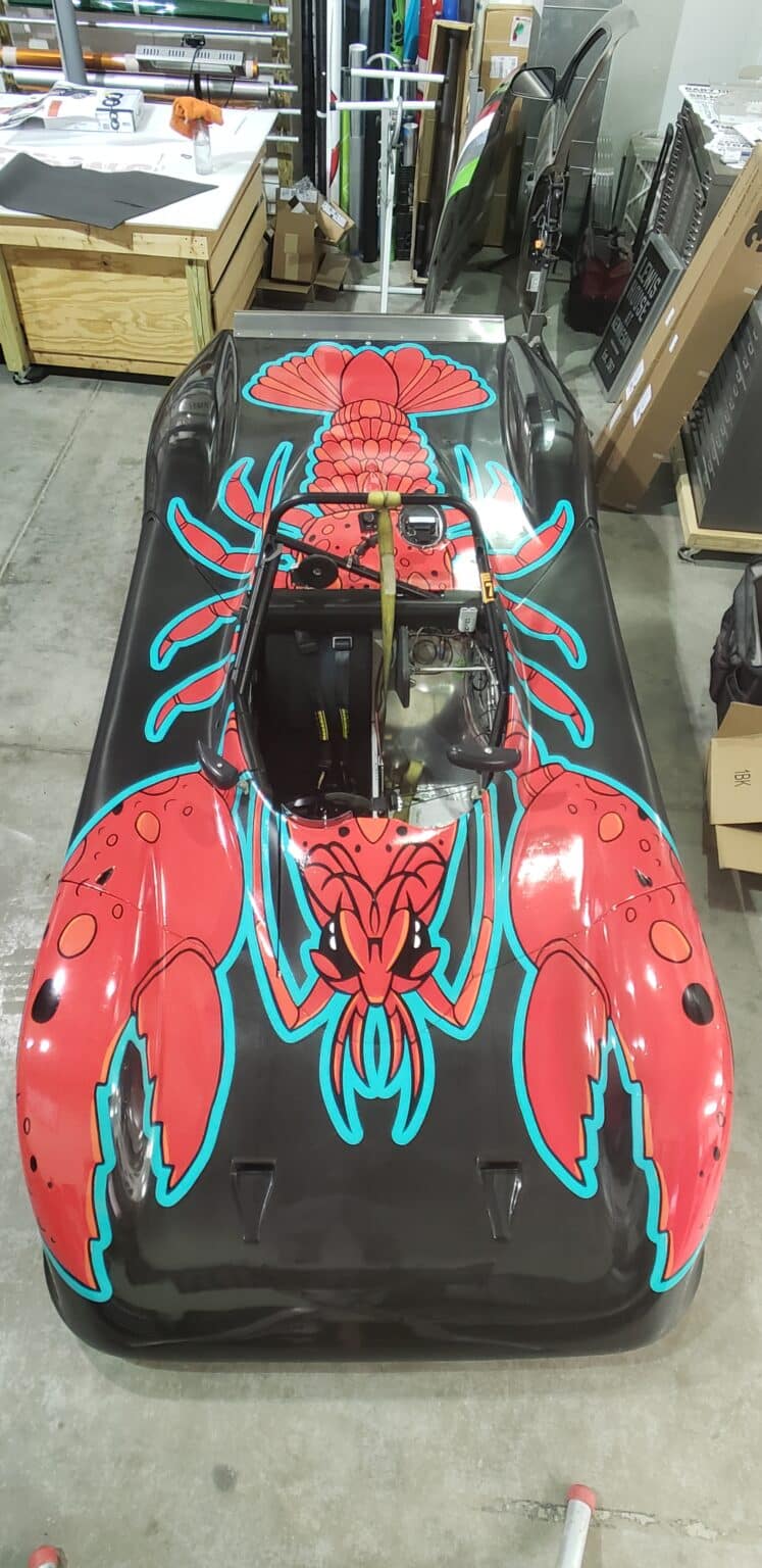 Hand-drawn crawfish race car wrap, by High Stakes Creative