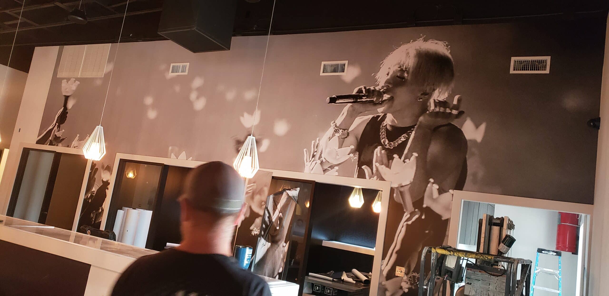 Concert crowd wallcovering for a restaurant and bar, by High Stakes Creative
