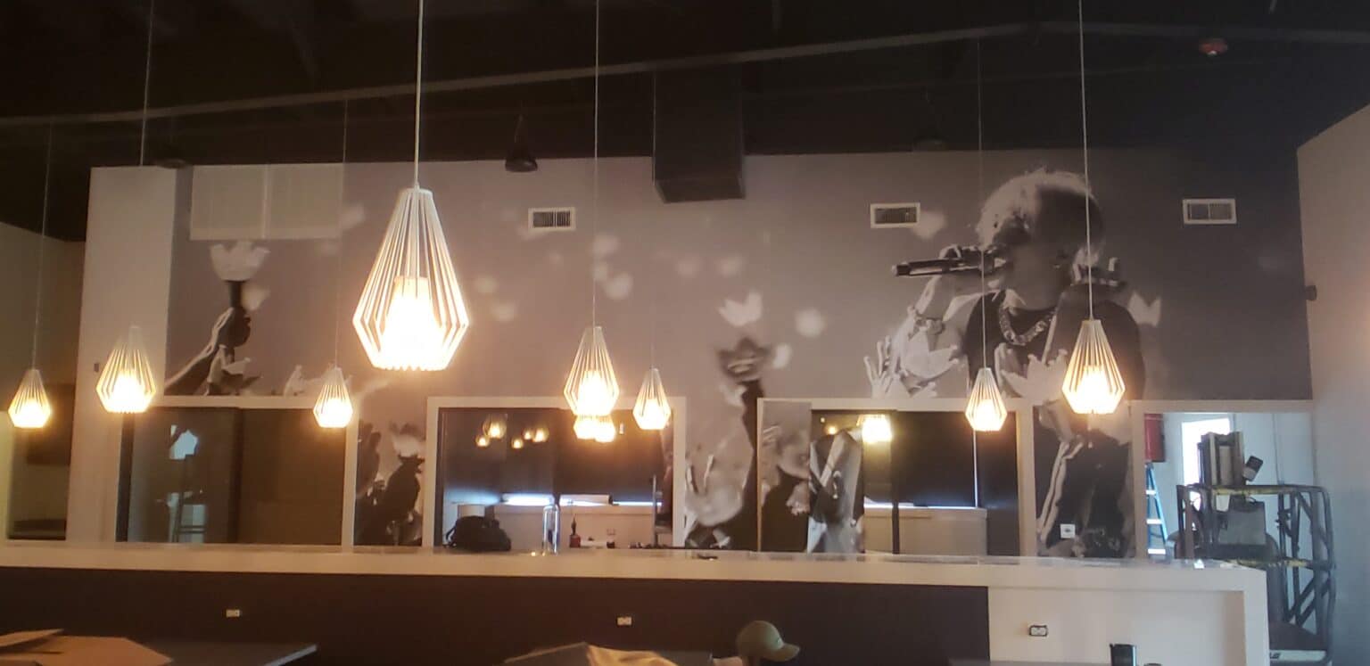 Concert crowd wallcovering for a restaurant and bar, by High Stakes Creative