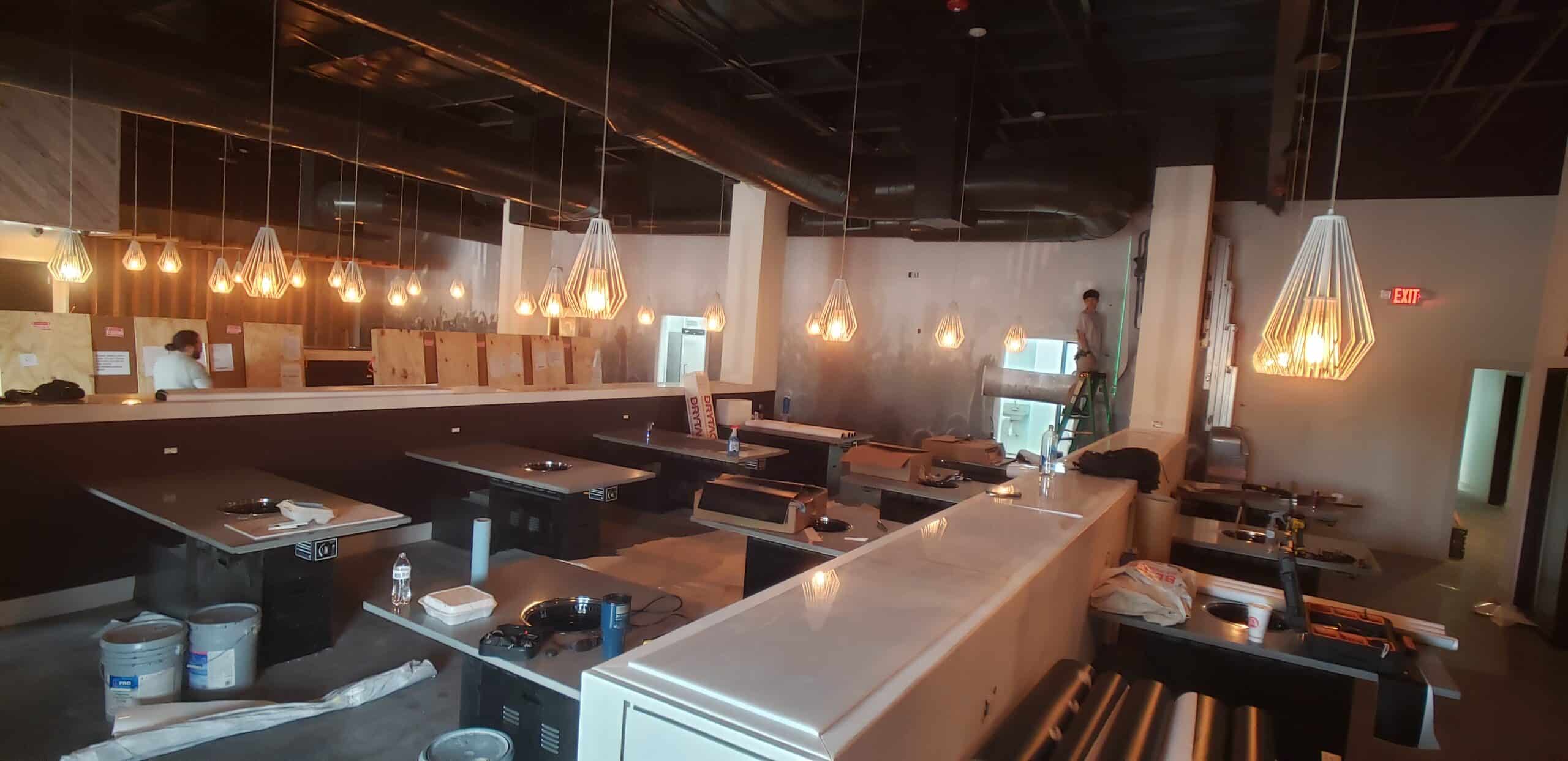 Concert crowd wallcovering for a restaurant and bar, by High Stakes Creative