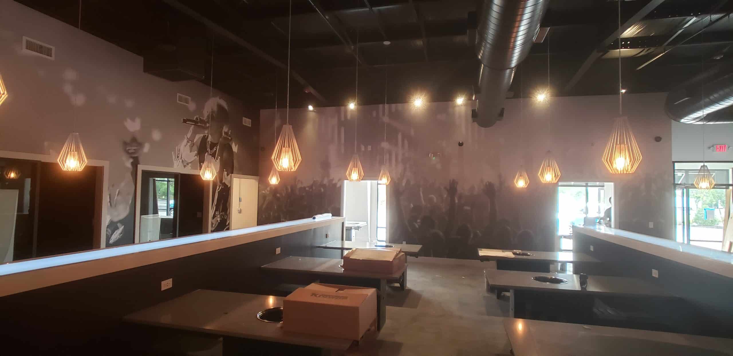 Concert crowd wallcovering for a restaurant and bar, by High Stakes Creative