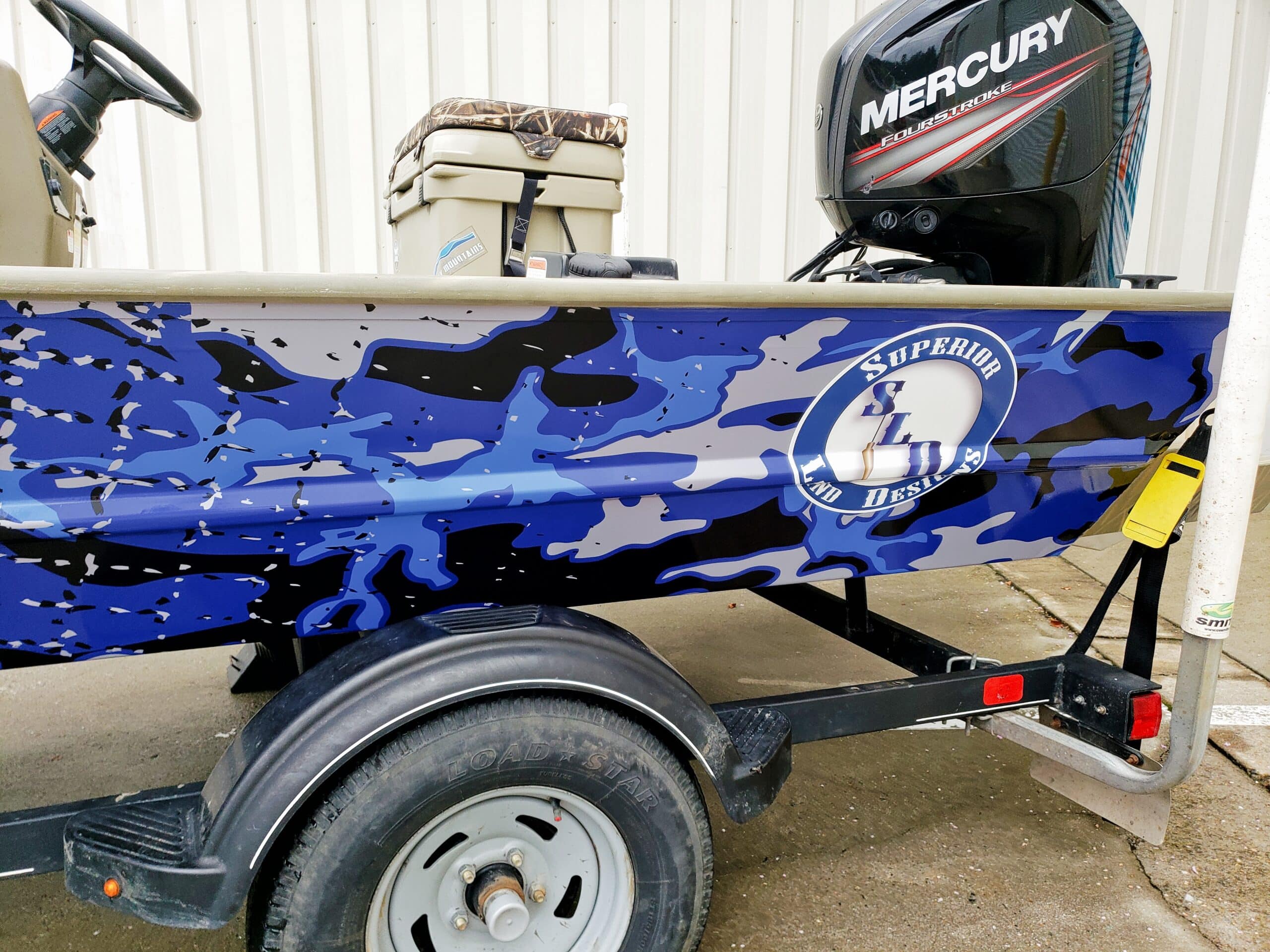 Blue camo boat wrap, by High Stakes Creative