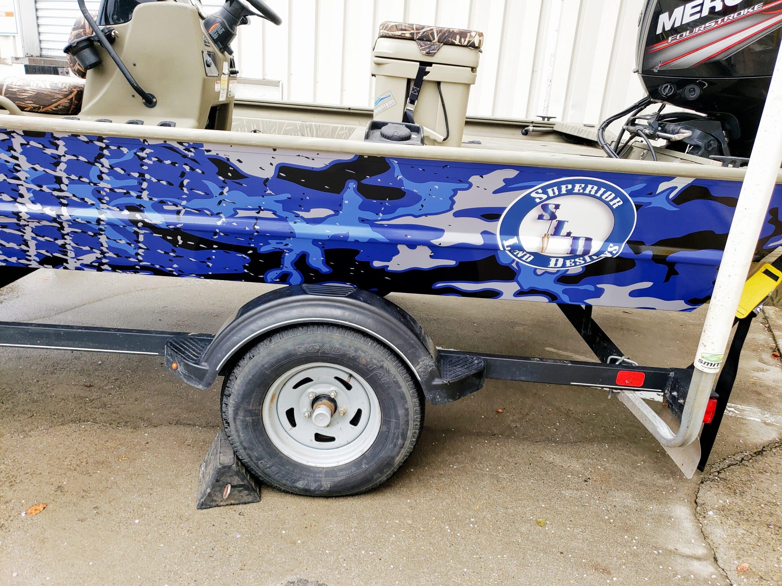 Blue camo boat wrap, by High Stakes Creative