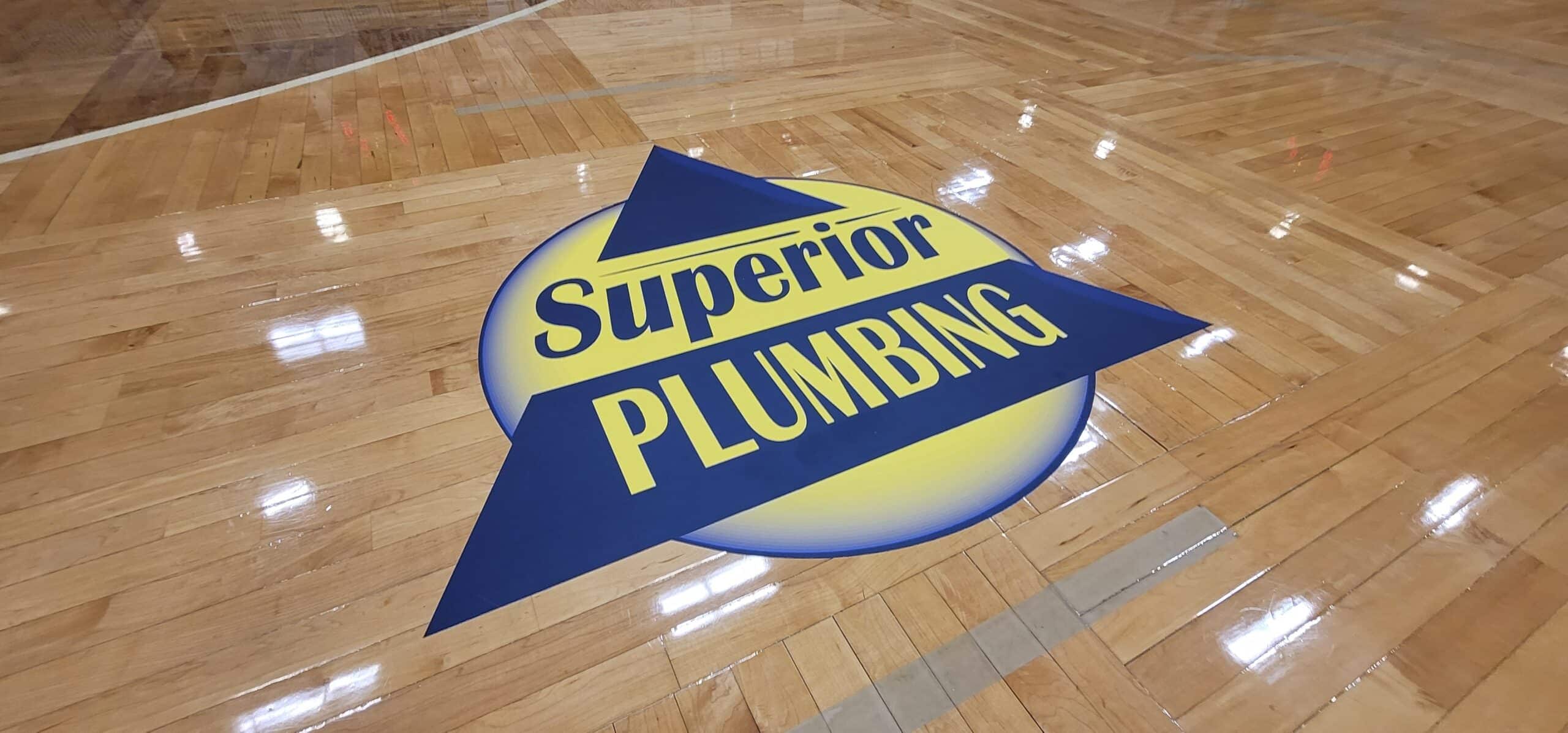 Gym floor logo graphics, Superior Plumbing, Kennesaw, GA, by High Stakes Creative