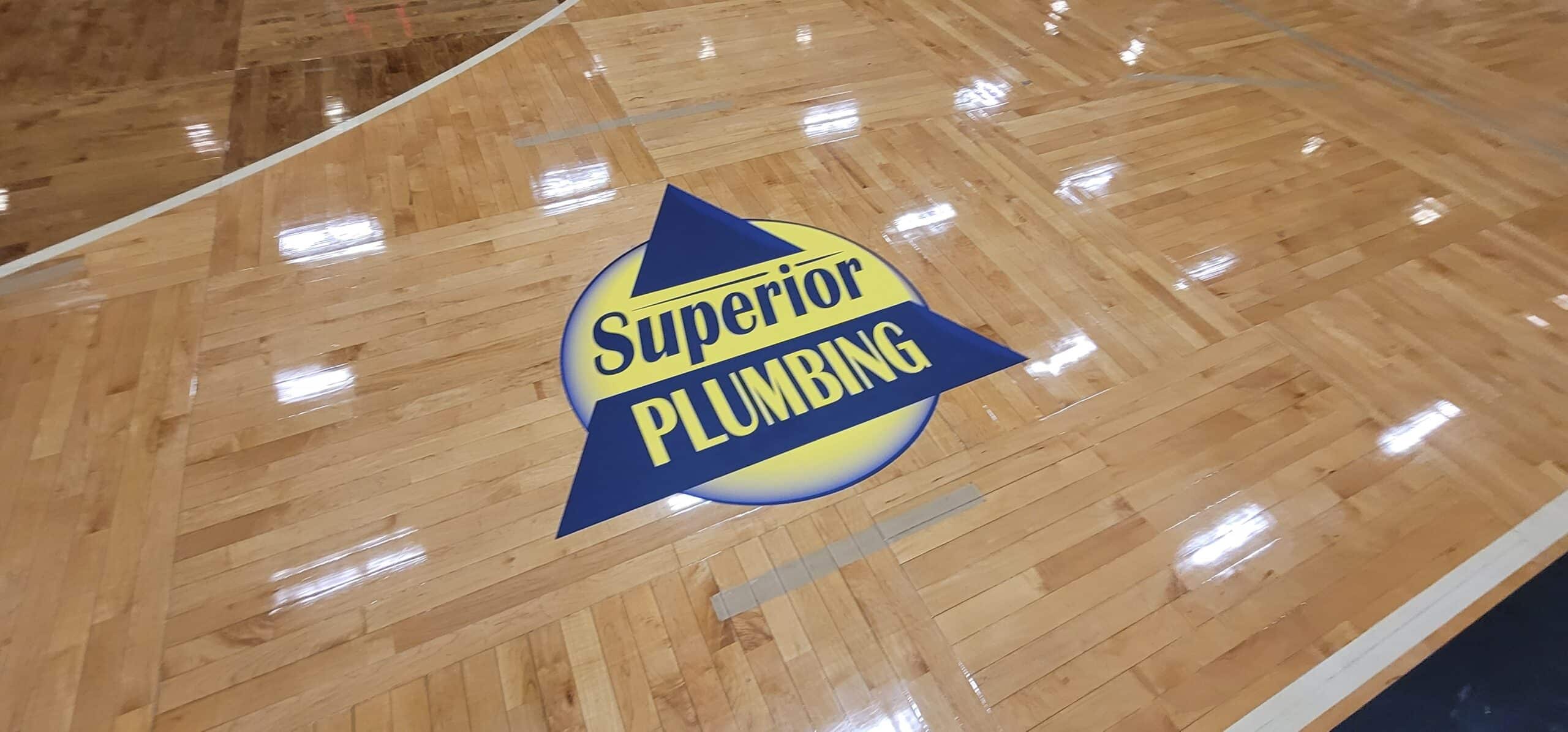 Gym floor logo graphics, Superior Plumbing, Kennesaw, GA, by High Stakes Creative