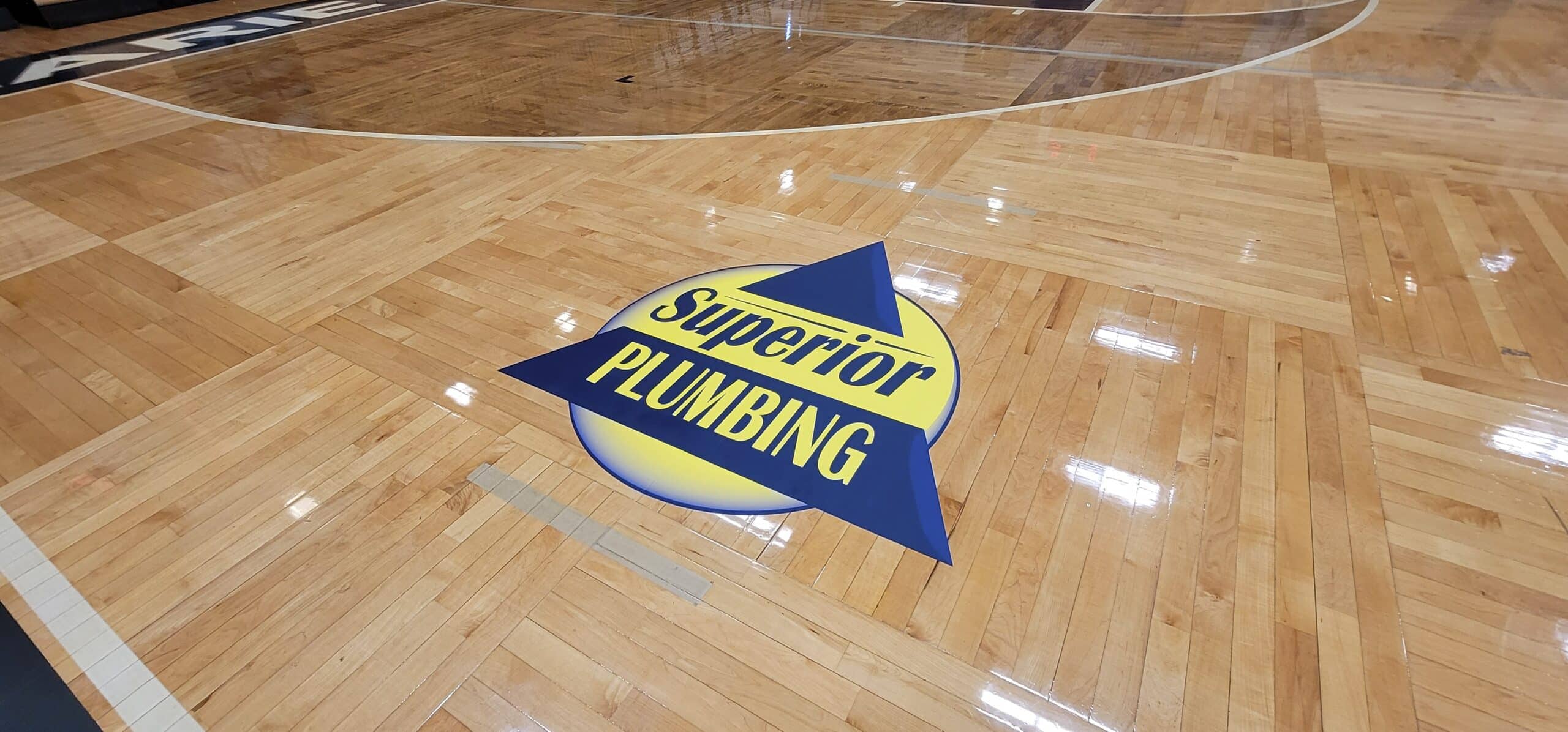 Gym floor logo graphics, Superior Plumbing, Kennesaw, GA, by High Stakes Creative