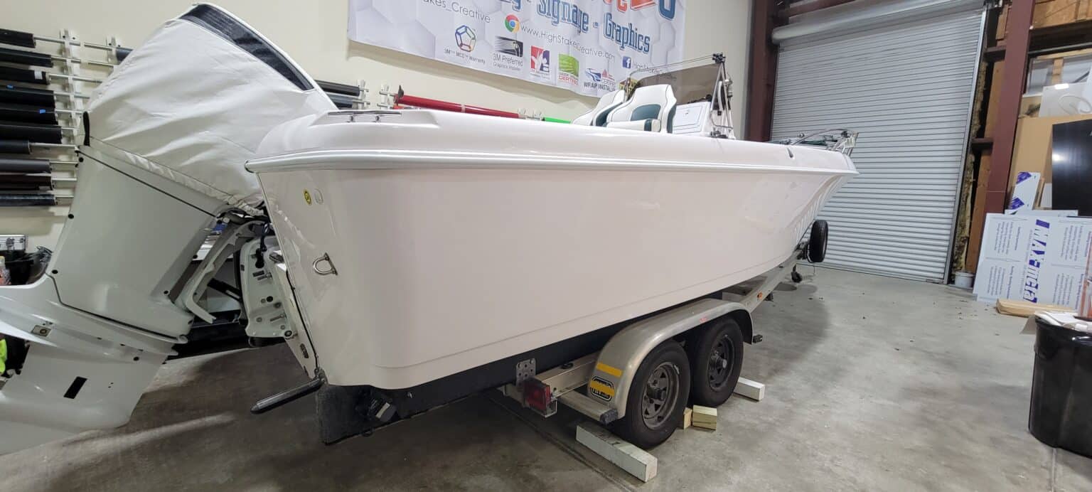 Boat hull before its woodgrain wrap, by High Stakes Creative