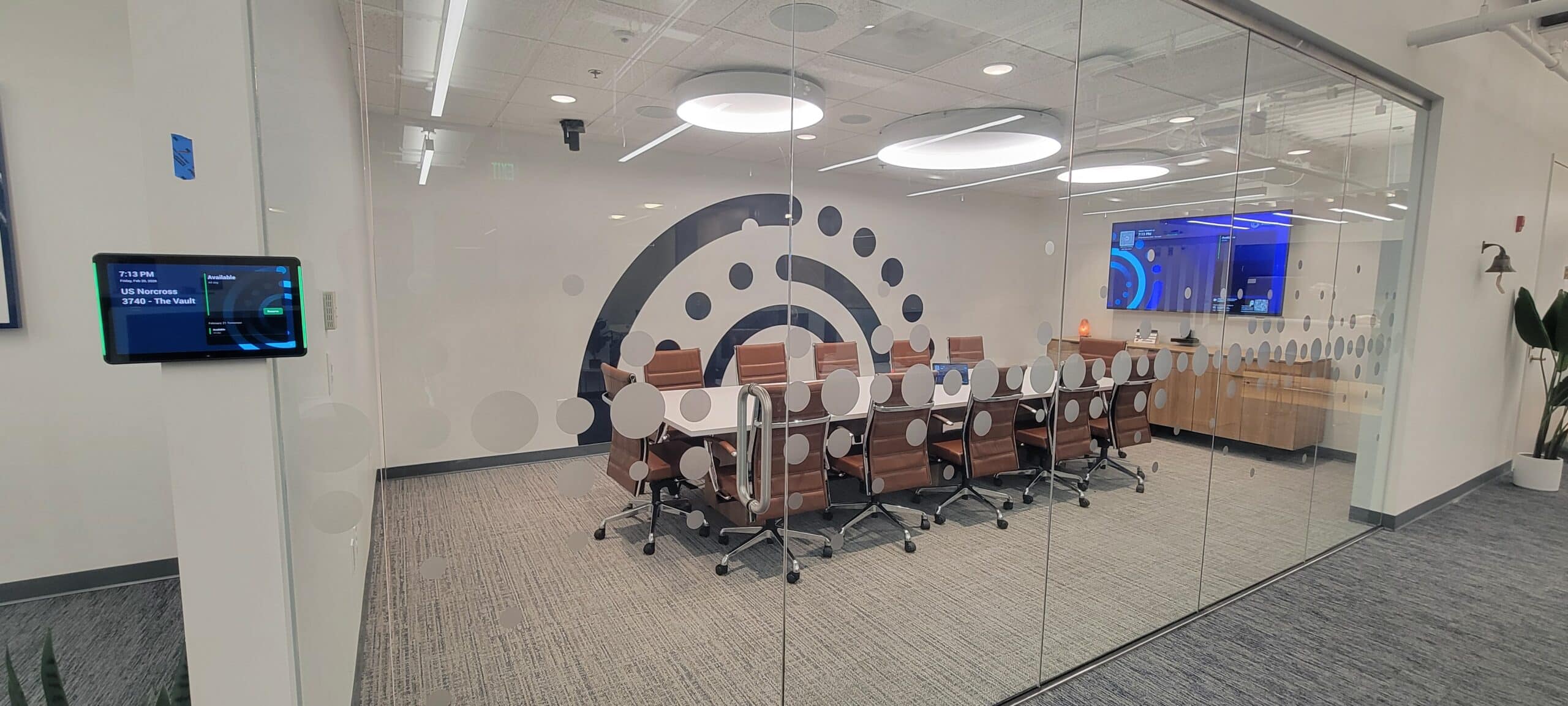 Brand mark wall behind conference room glass, Informa, Sandy Springs, GA, by High Stakes Creative