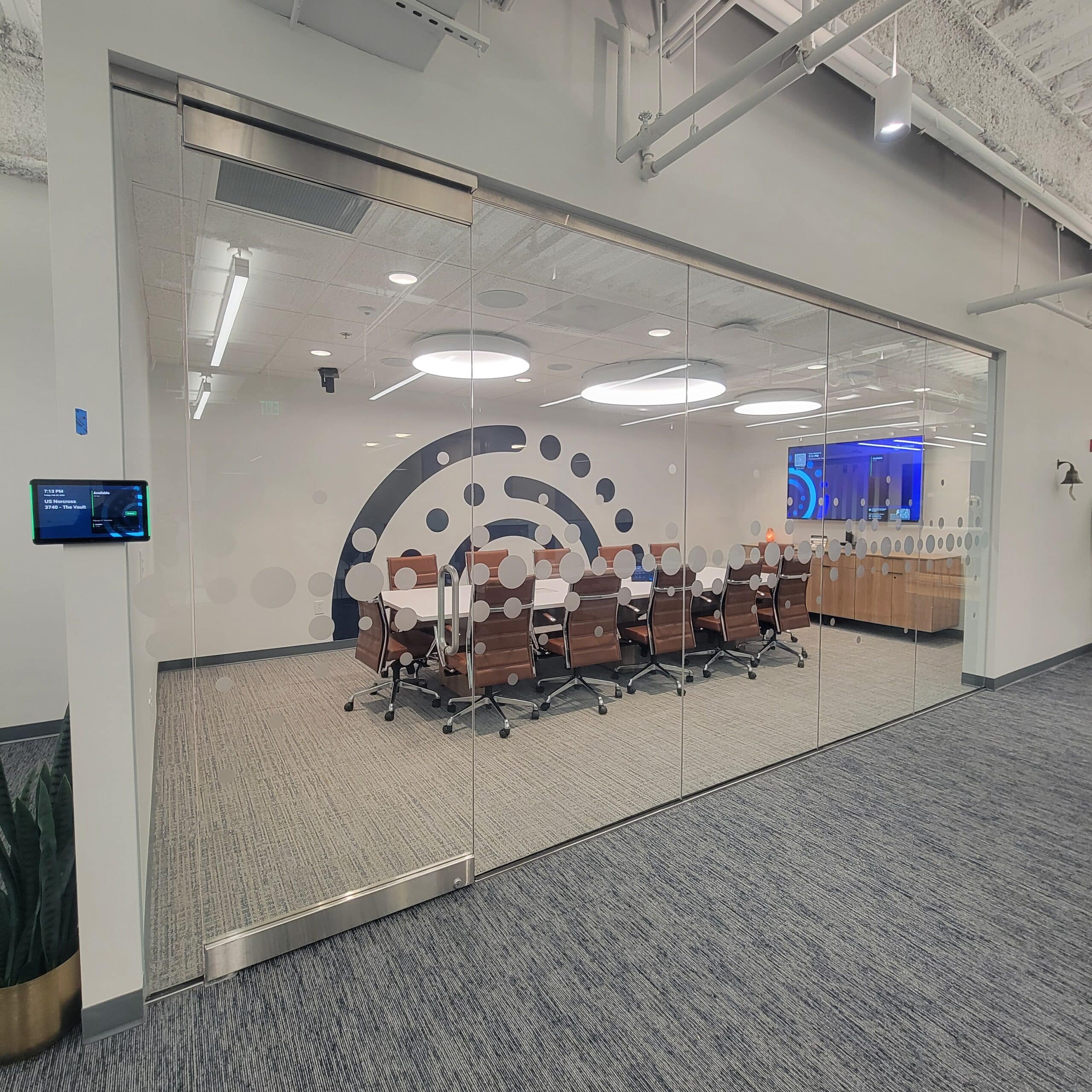 Brand mark wall behind conference room glass, Informa, Sandy Springs, GA, by High Stakes Creative