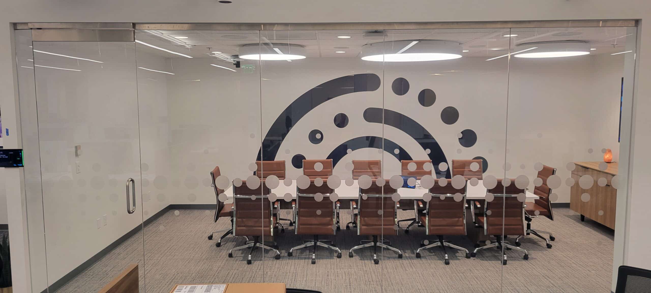 Brand mark wall behind conference room glass, Informa, Sandy Springs, GA, by High Stakes Creative