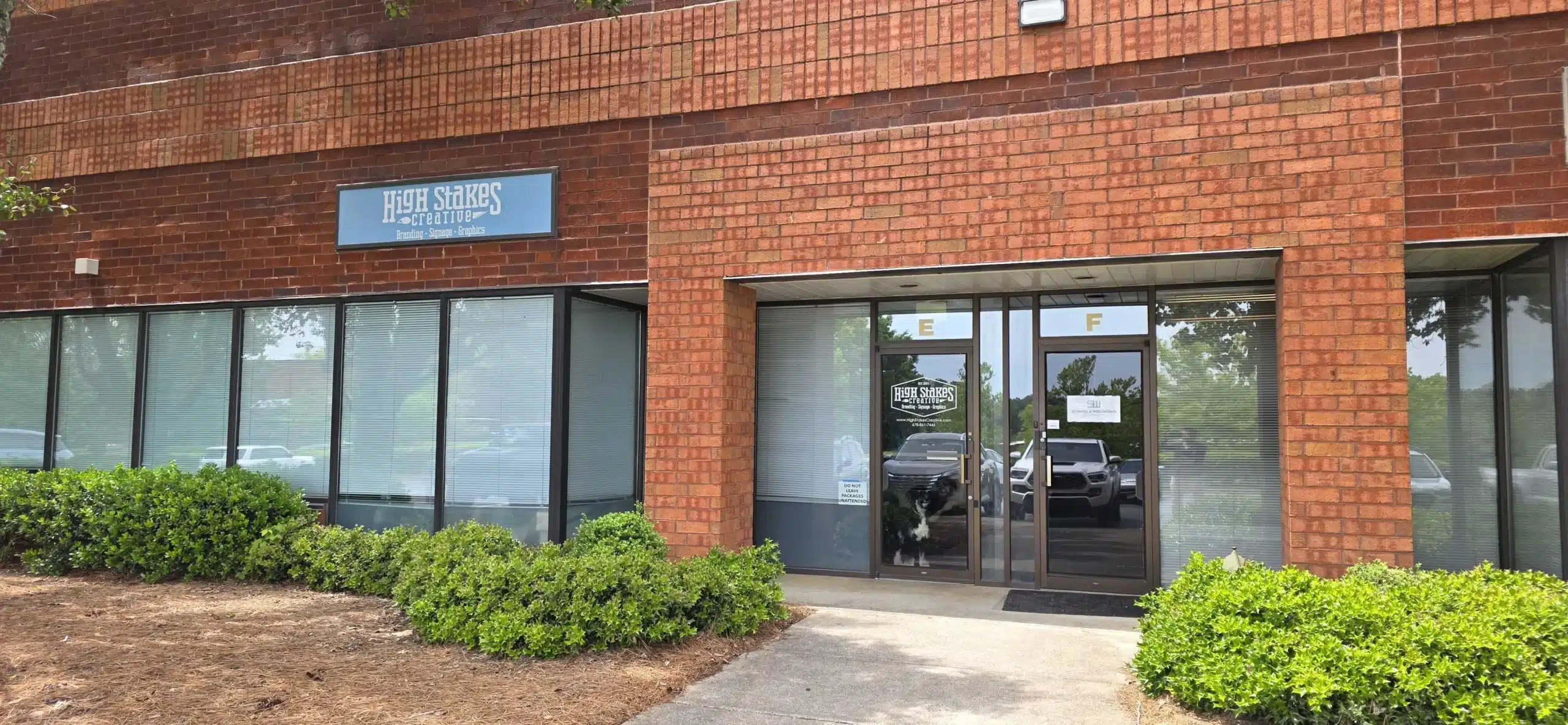 Architectural signage at a building entrance reinforcing brand identity and enhancing visibility