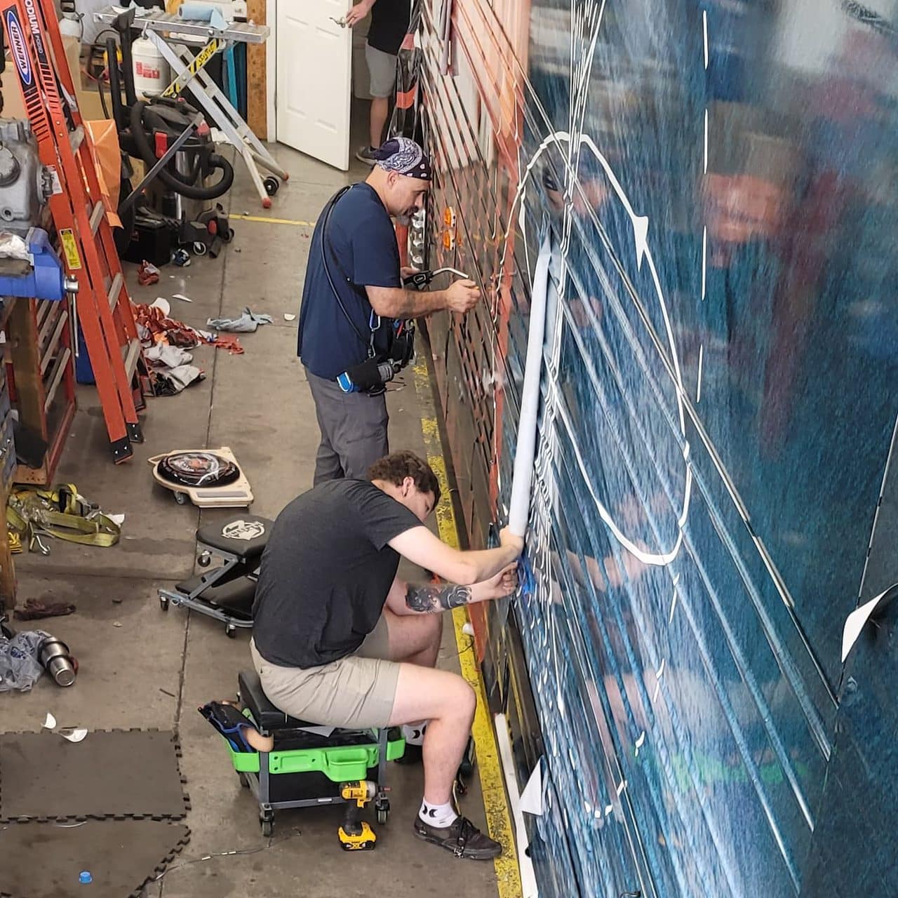 Installing a tour bus wrap, Reckless Isolation, by High Stakes Creative