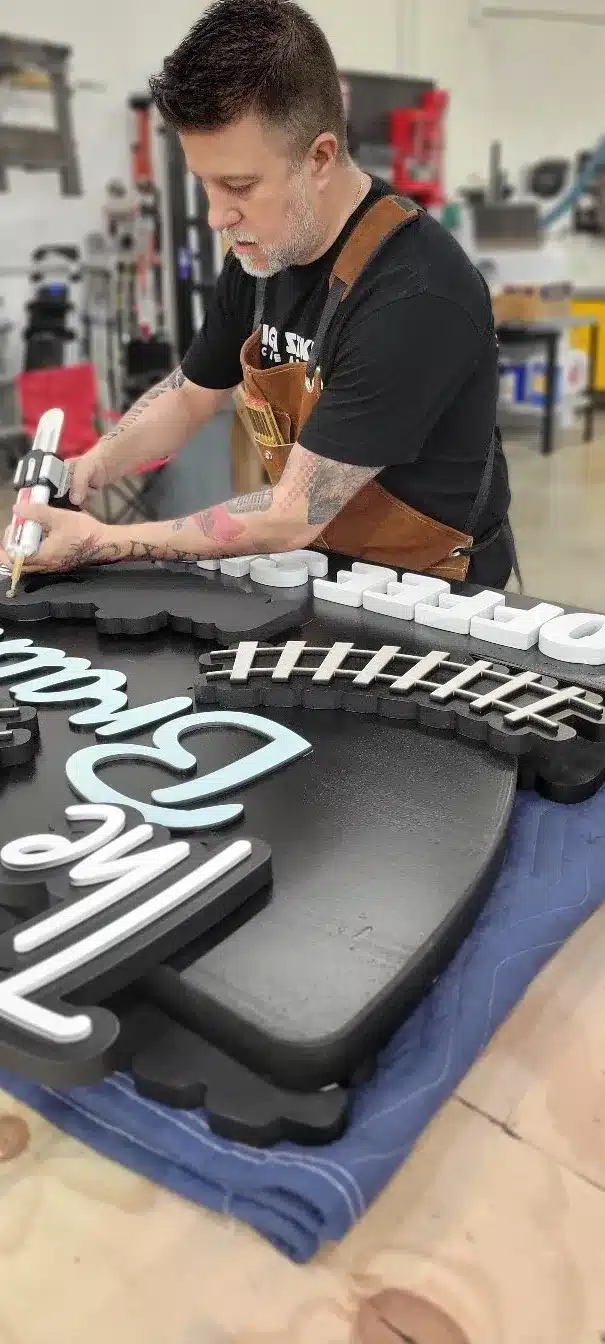 Professional team installing custom signage, emphasizing quality and attention to detail in the process