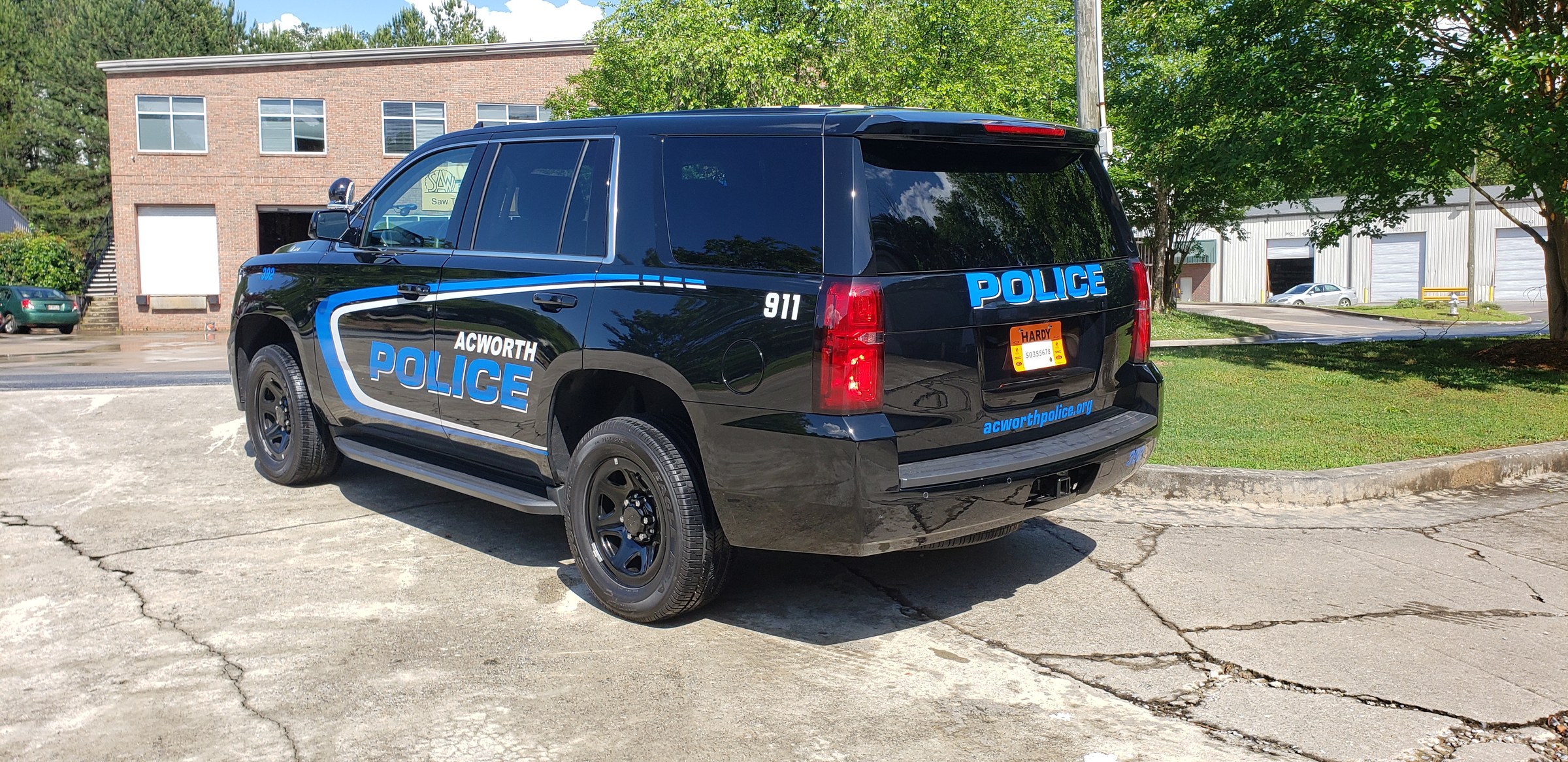 Rear three-quarter of Acworth Police Tahoe, POLICE rear lettering and 911, Acworth Police, Acworth, GA, by High Stakes Creative