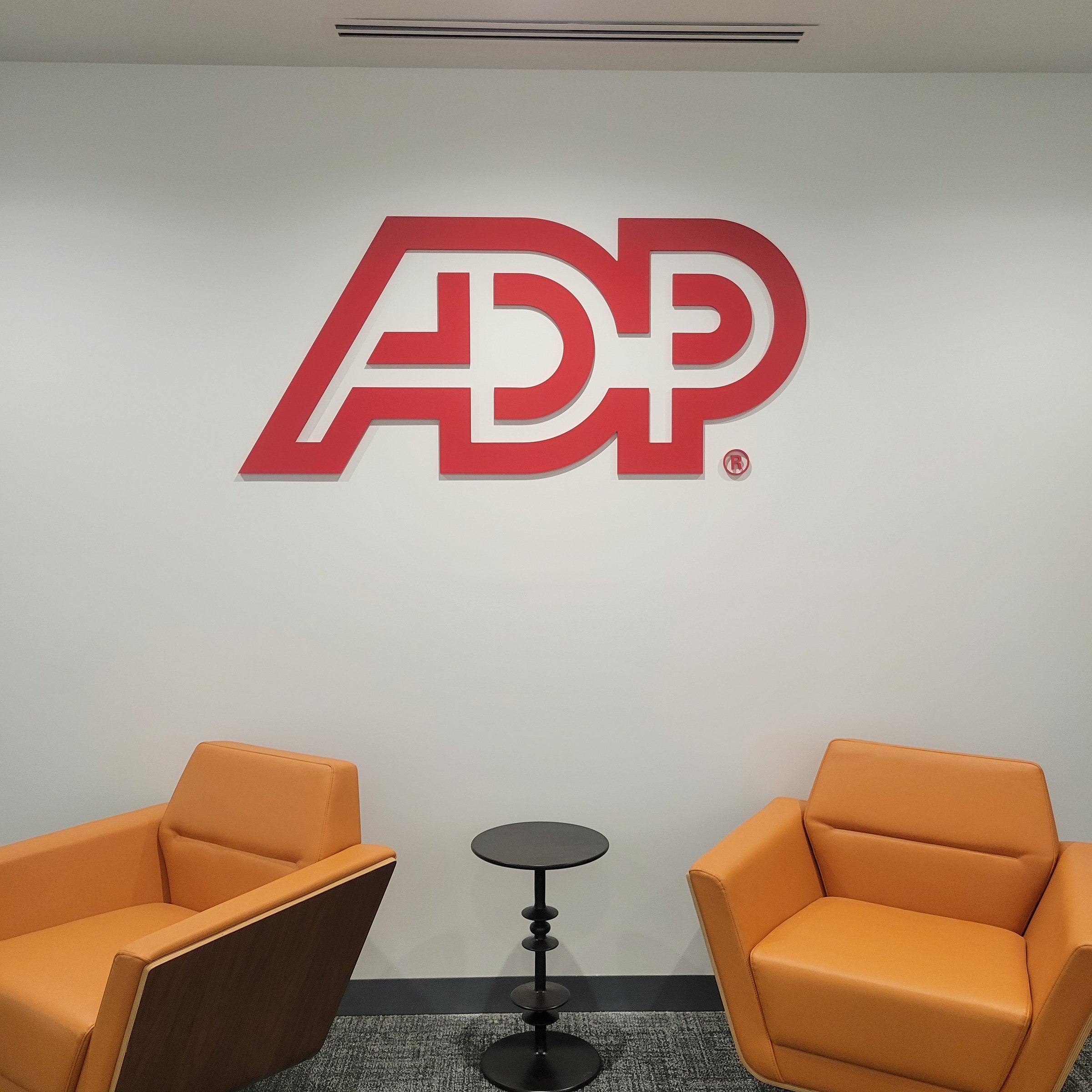 Lobby dimensional logo wall with lounge seating, ADP, by High Stakes Creative