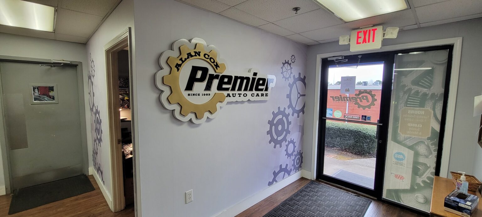 Dimensional gear logo and gear wall graphics in lobby, Alan Cox Premier Auto Care, by High Stakes Creative