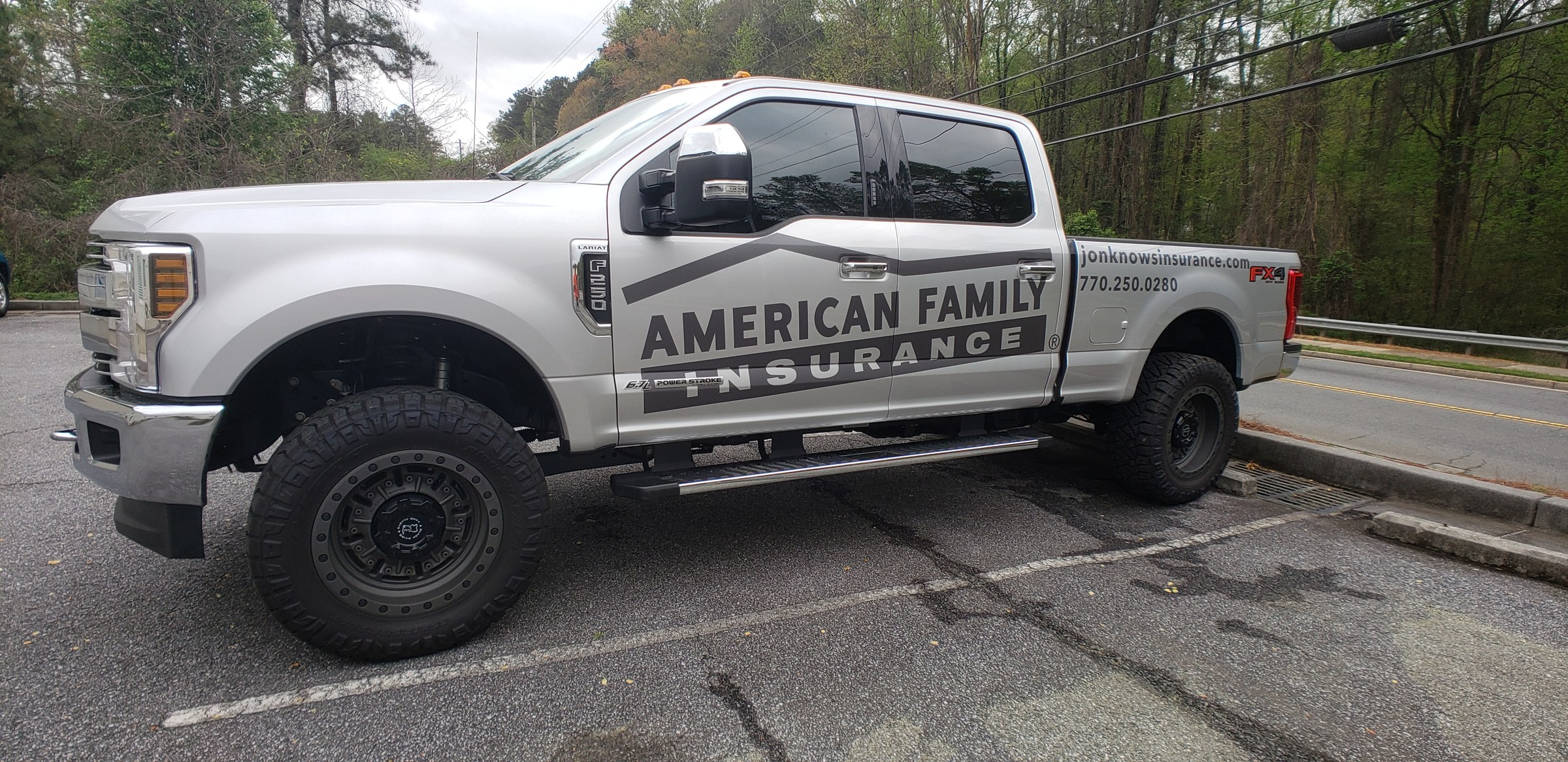 Large side lettering and swoosh graphics on a silver Ford F-250 (jonknowsinsurance.com), American Family Insurance, by High Stakes Creative