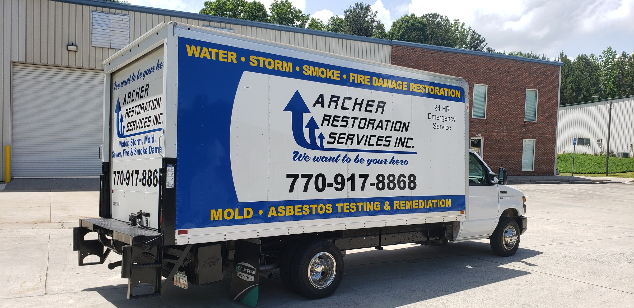 Rear three-quarter of box truck showing side and rear door graphics, Archer Restoration Services, by High Stakes Creative