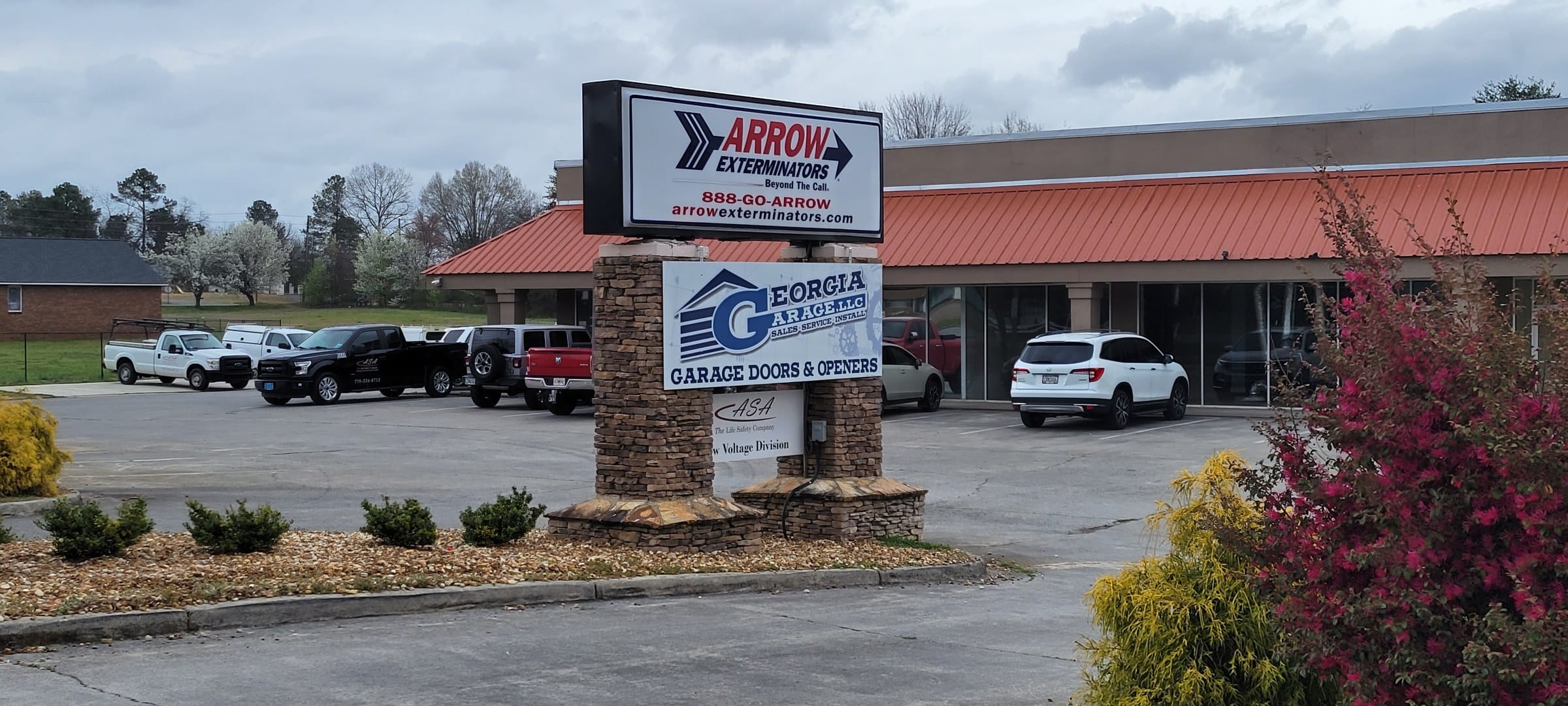 Pylon, wider view with plaza, Arrow Exterminators, by High Stakes Creative