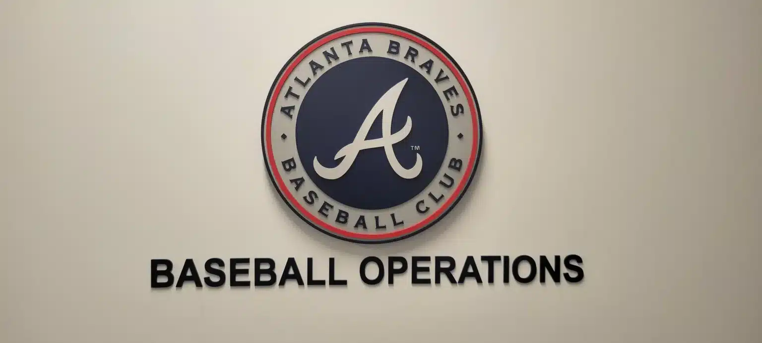 Dimensional Atlanta Braves Baseball Club logo above raised Baseball Operations lettering on a light office wall, by High Stakes Creative