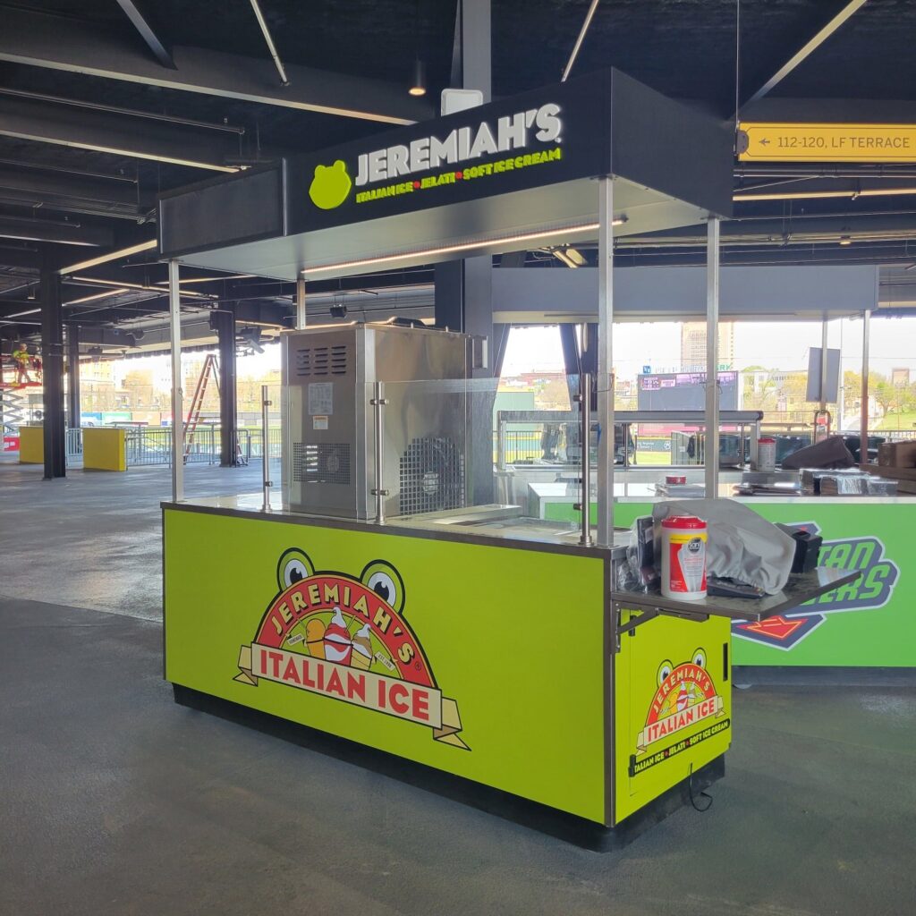 Wrapped concession carts at a ballpark concourse: Jeremiah's Italian Ice carts, Spartan Bu, Jeremiah's Italian Ice, by High Stakes Creative