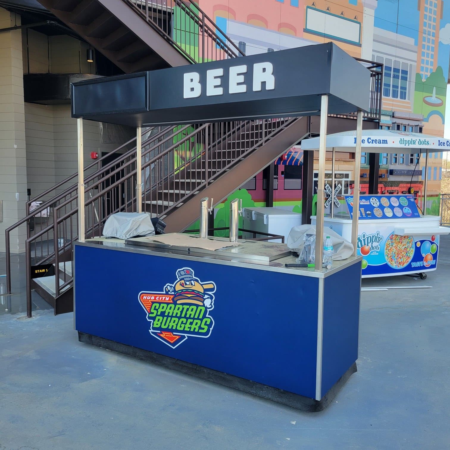 Wrapped concession carts at a ballpark concourse: Jeremiah's Italian Ice carts, Spartan Bu, Jeremiah's Italian Ice, by High Stakes Creative