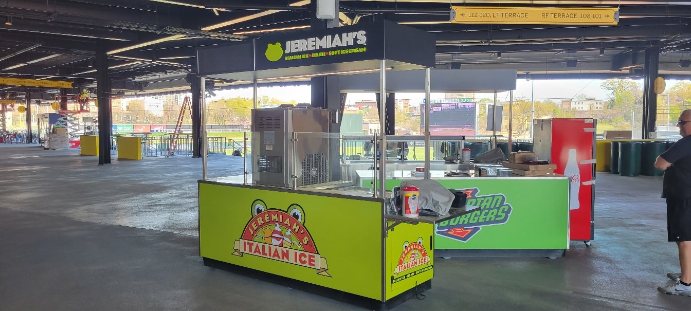Wrapped concession carts at a ballpark concourse: Jeremiah's Italian Ice carts, Spartan Bu, Jeremiah's Italian Ice, by High Stakes Creative