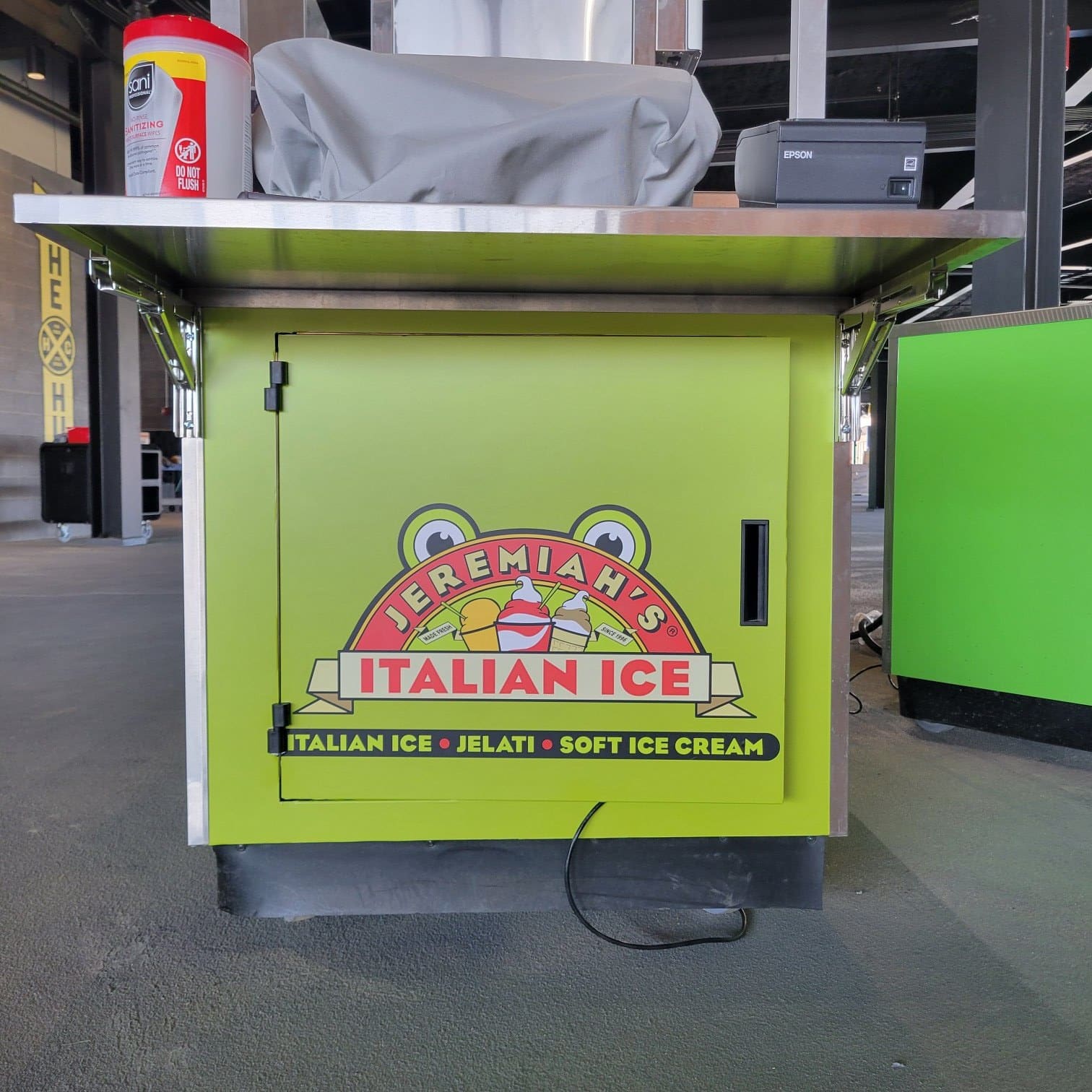 Wrapped concession carts at a ballpark concourse: Jeremiah's Italian Ice carts, Spartan Bu, Jeremiah's Italian Ice, by High Stakes Creative