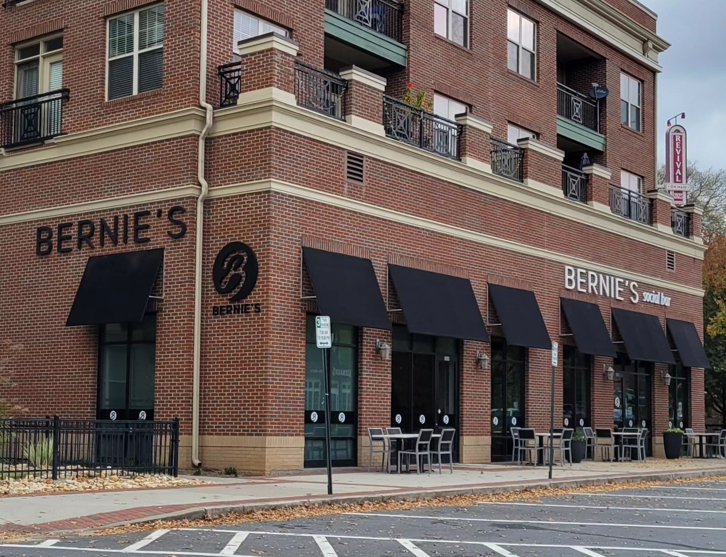 Corner of brick mixed-use building with Bernie's letters and logo, Bernie's, by High Stakes Creative