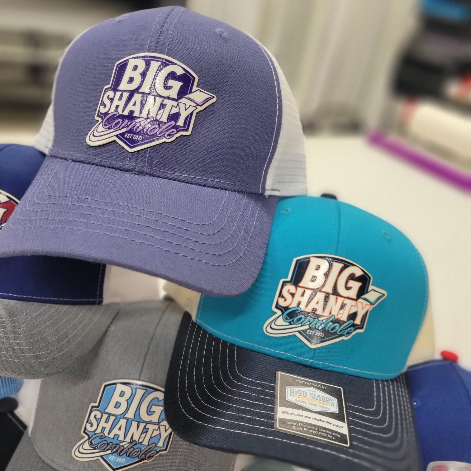 Collection of custom patch hats in multiple colorways, Big Shanty Cornhole, by High Stakes Creative