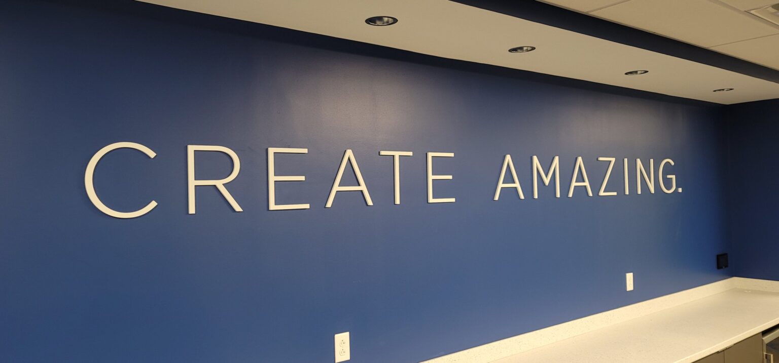 'Create Amazing' dimensional letters on blue feature wall, Burns & McDonnell, by High Stakes Creative