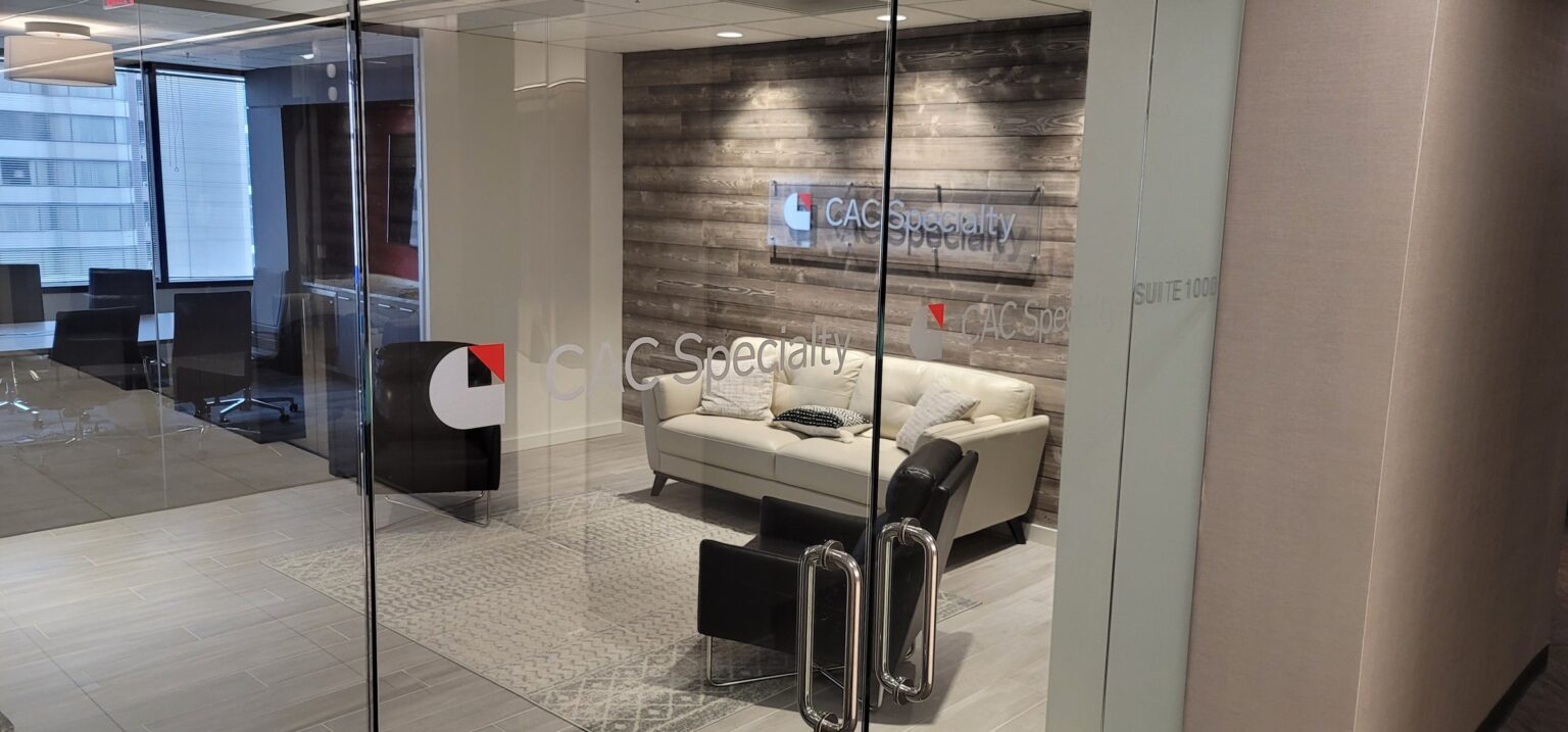 Glass entry logo graphics and standoff acrylic logo on wood-plank lobby wall, Suite 1000, CAC Specialty, Atlanta, GA, by High Stakes Creative
