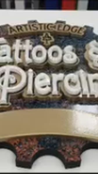 Video: Carved Artistic Edge Tattoos & Piercing sign (1:05)