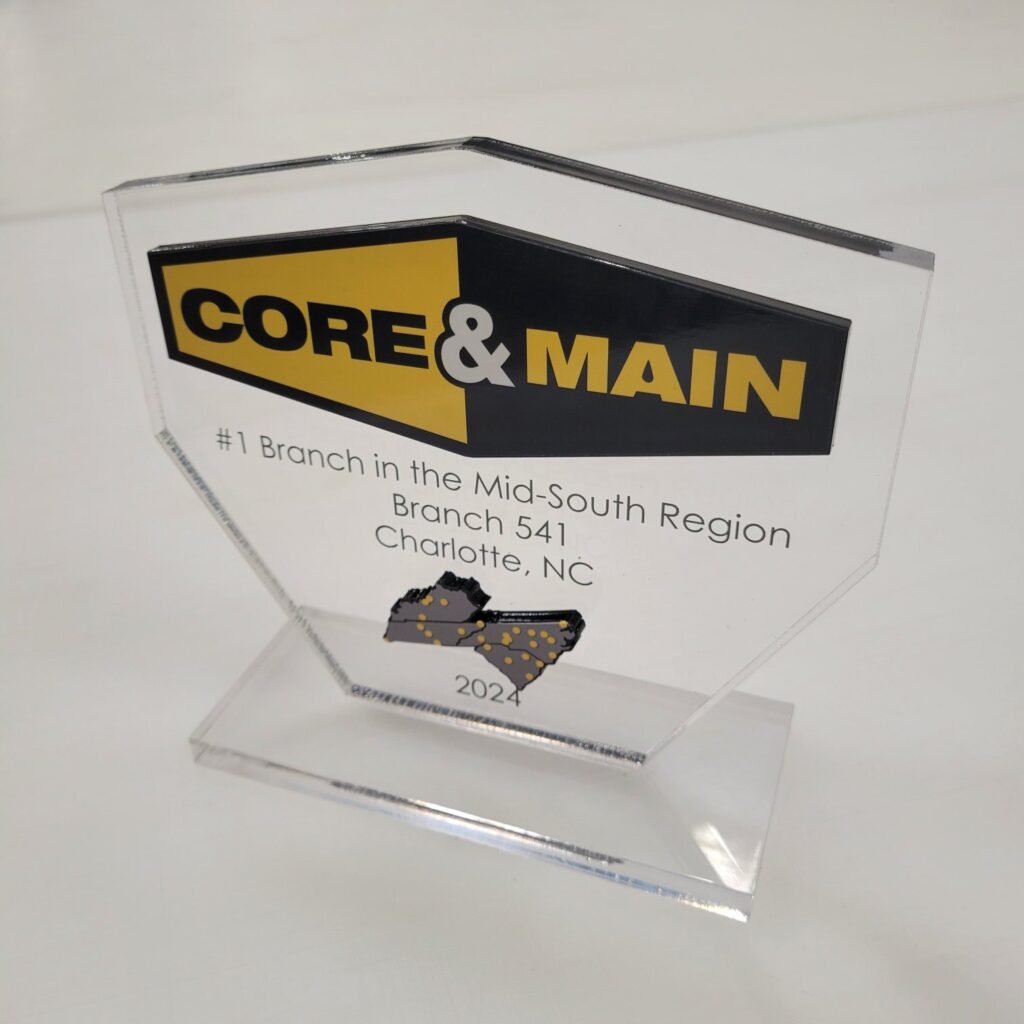 Clear acrylic branch awards printed with Core & Main logo and region map, plus engraved le, Core & Main, by High Stakes Creative