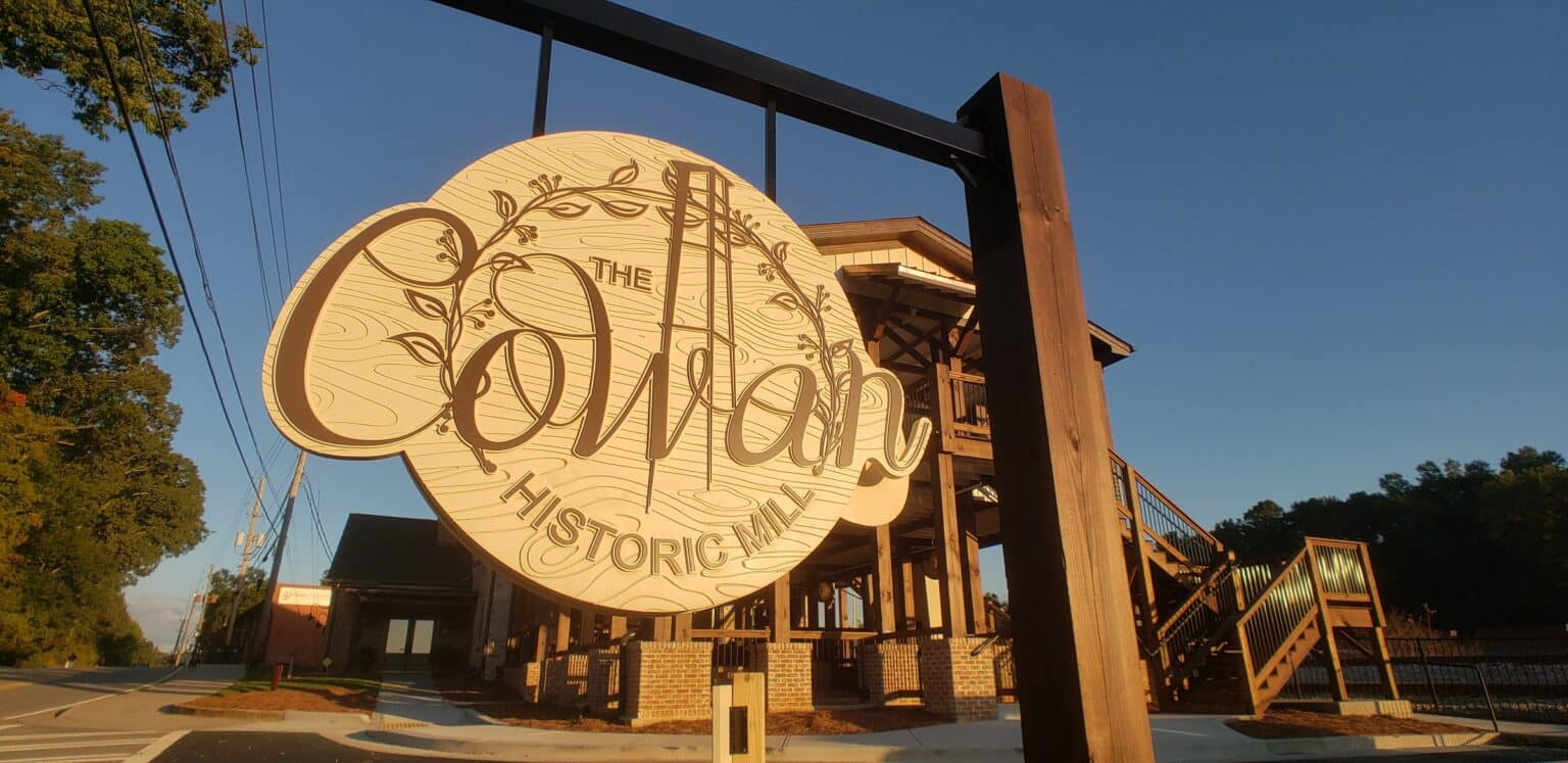 Carved hanging sign with mill tower and vine motif, The Cowan Historic Mill, Acworth, GA, by High Stakes Creative