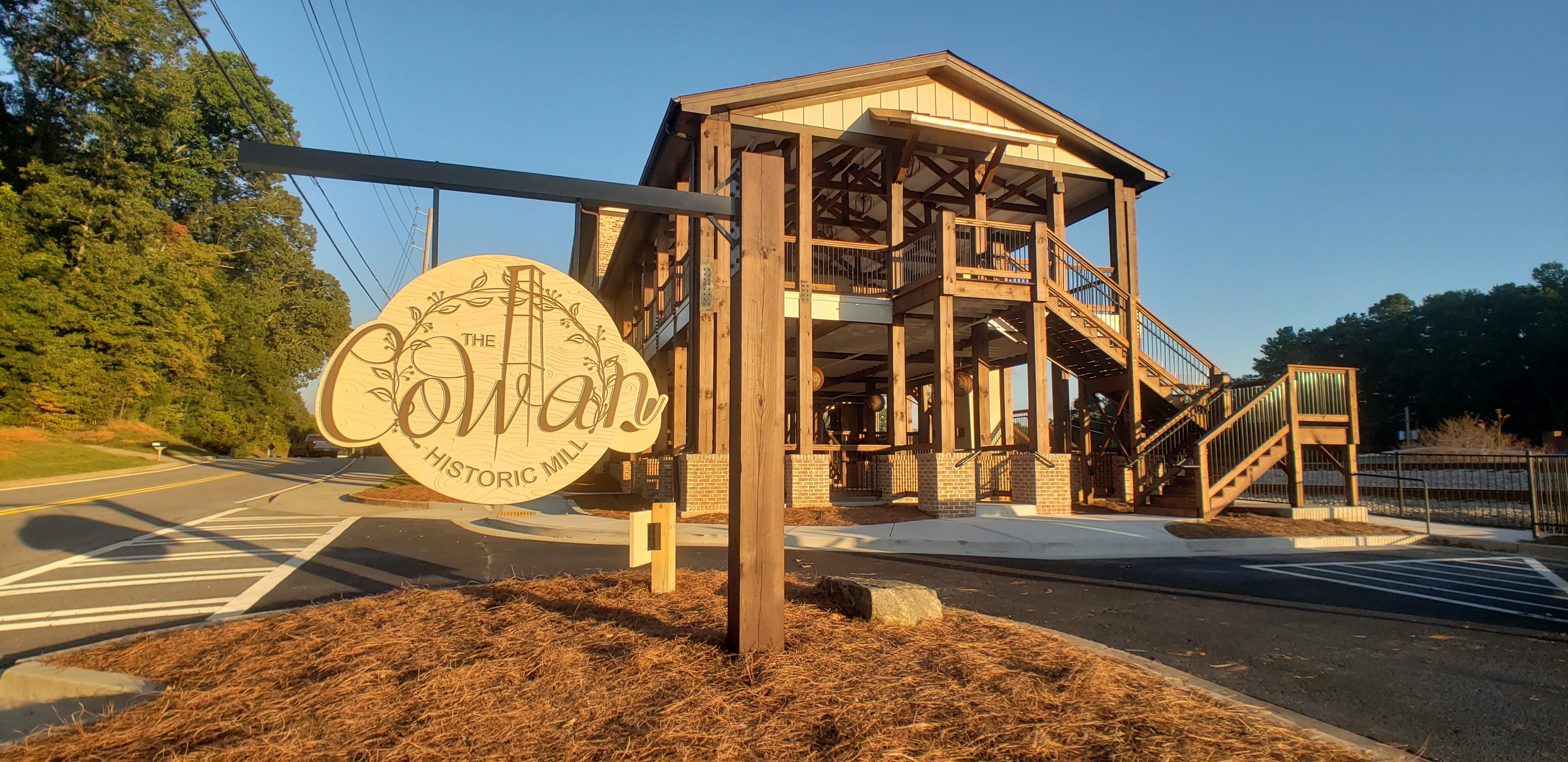 Carved hanging sign in front of the mill, The Cowan Historic Mill, Acworth, GA, by High Stakes Creative