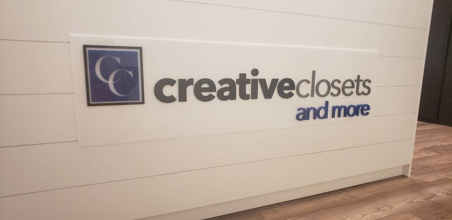 Dimensional logo panel on white shiplap reception desk, Creative Closets and More, by High Stakes Creative