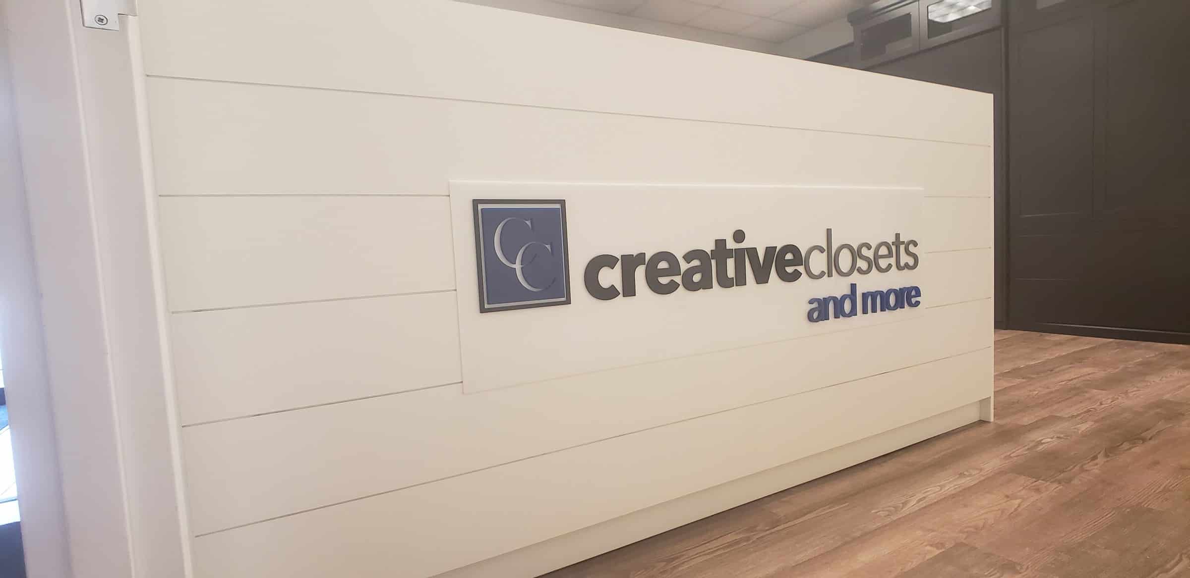 Dimensional logo panel on white shiplap reception desk, Creative Closets and More, by High Stakes Creative