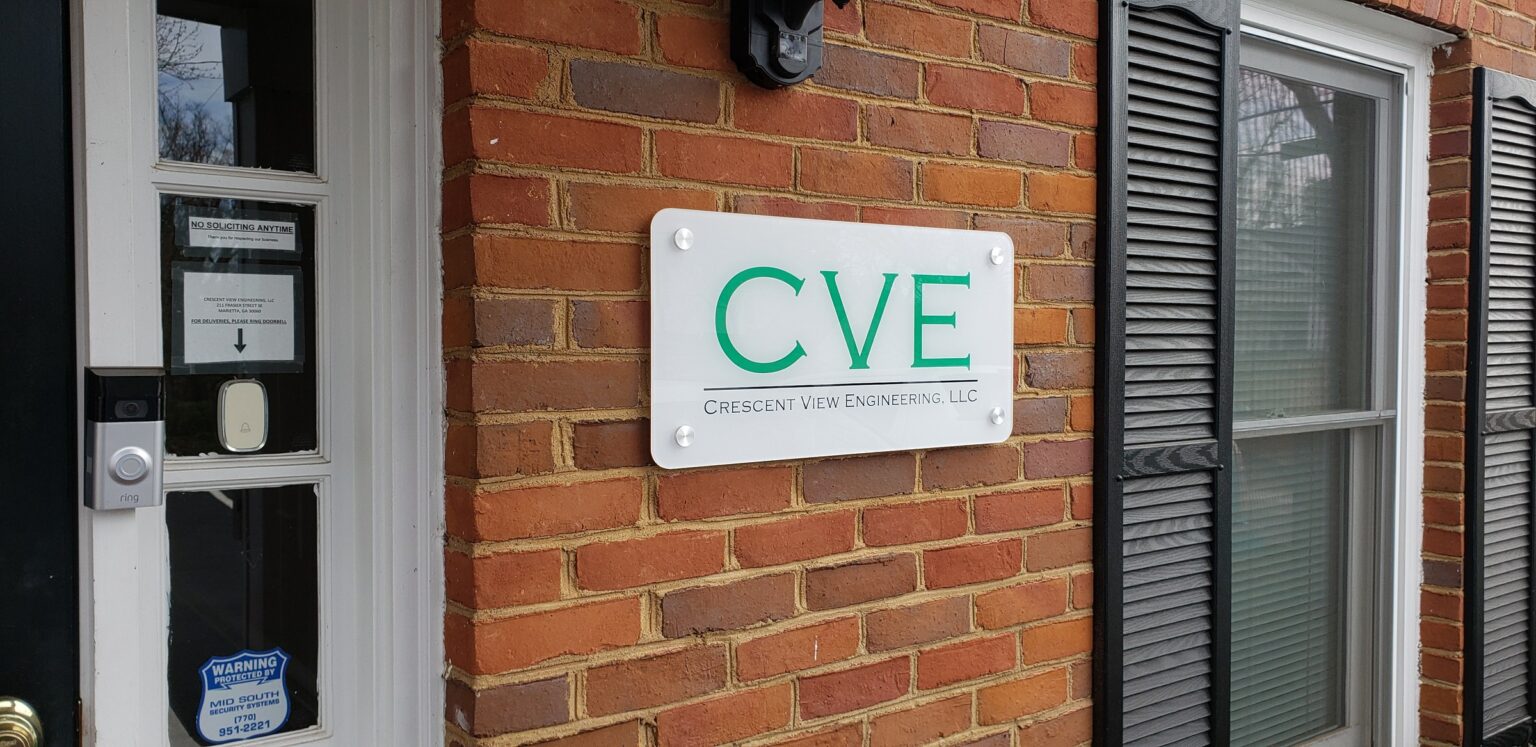 Standoff acrylic CVE plaque on brick beside entry door, Crescent View Engineering, by High Stakes Creative