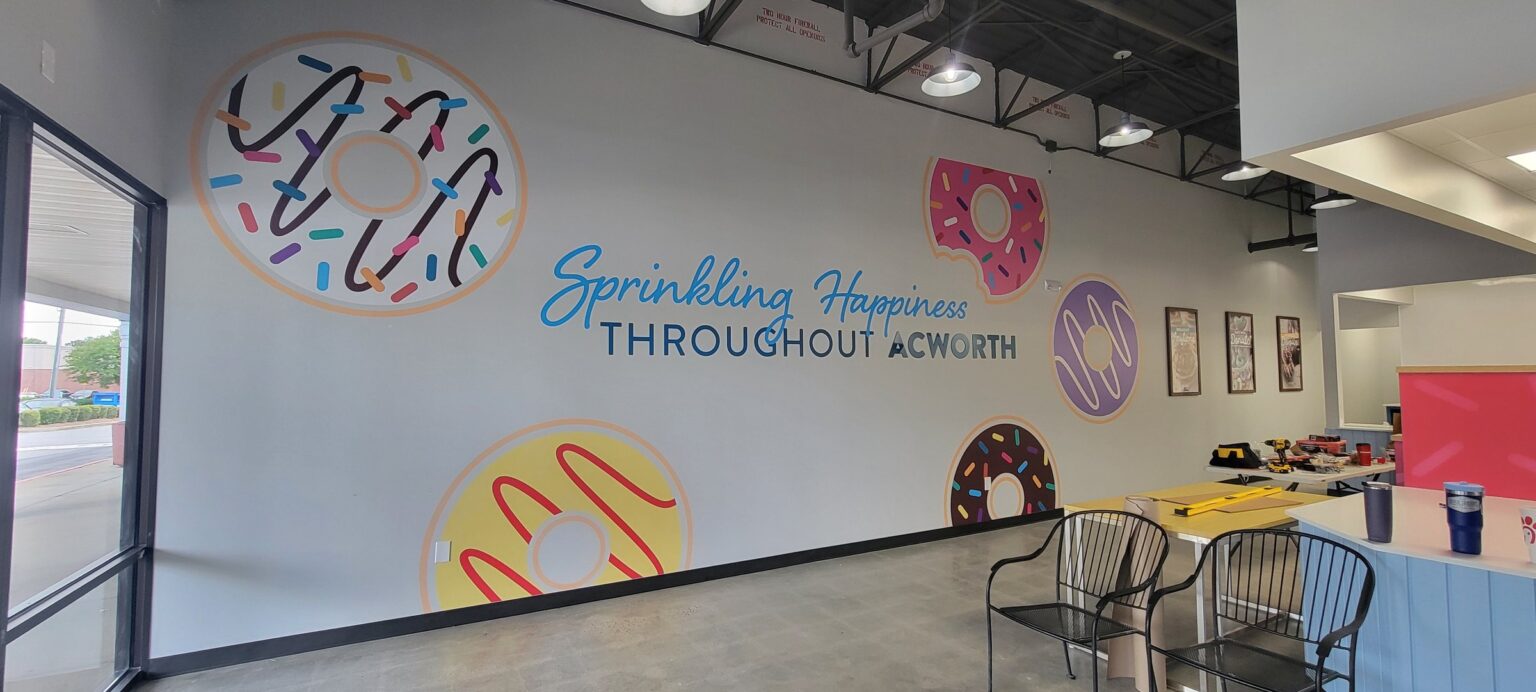 Donut wall mural with 'Sprinkling Happiness Throughout Acworth' lettering, Duck Donuts, Acworth, GA, by High Stakes Creative