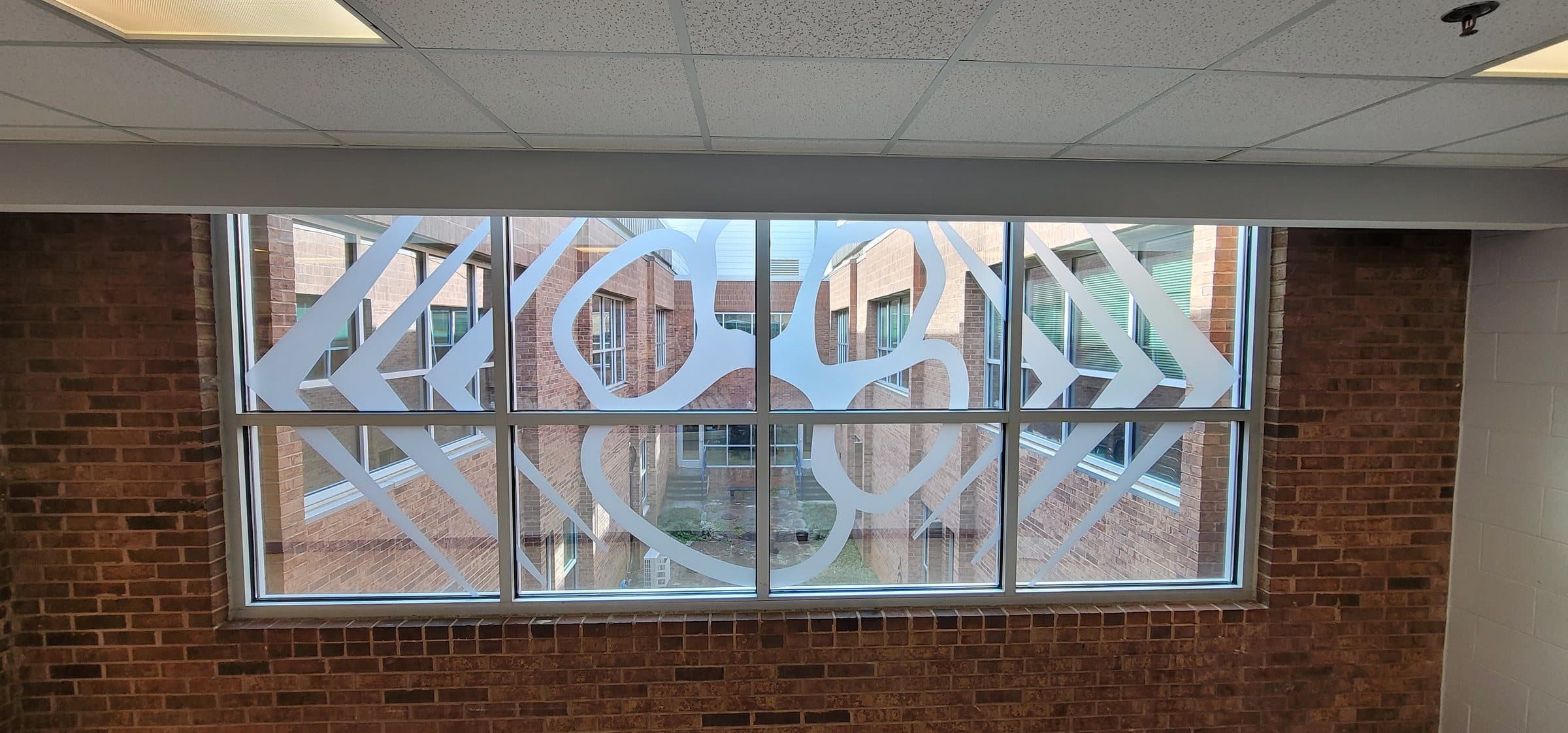 Decorative cut window film on hallway windows, Dunwoody High School, Dunwoody, GA, by High Stakes Creative