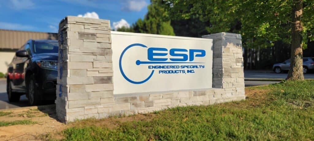 Stone monument with ESP logo panel, Engineered Specialty Products, (ESP), by High Stakes Creative