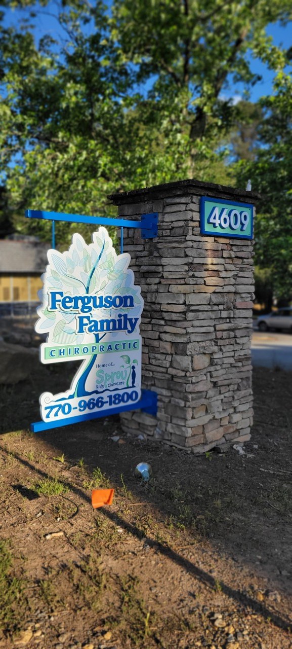 Leaf-shaped blade sign on stone pillar with 4609 address, Ferguson Family Chiropractic, by High Stakes Creative