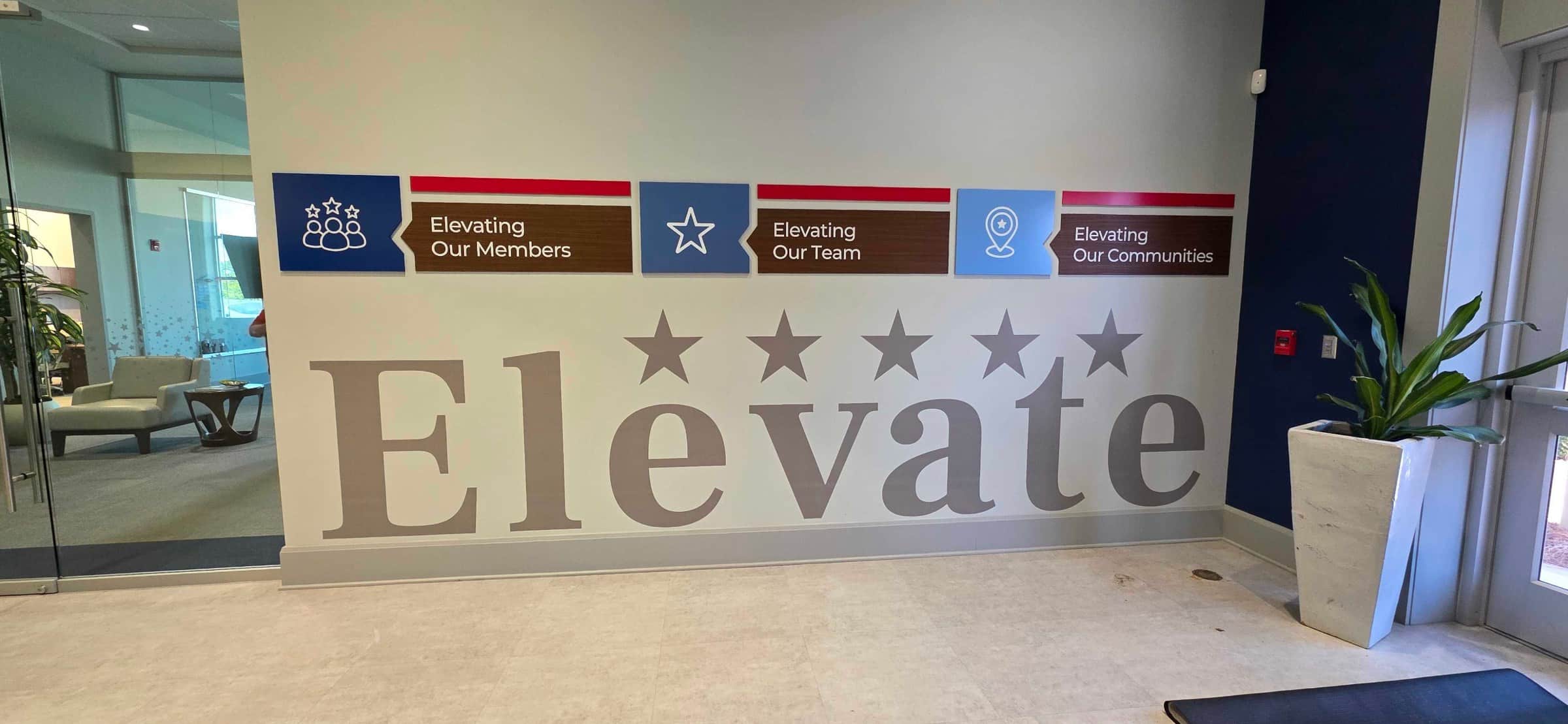 "Elevate" lobby vinyl letters and blue acrylic panels, Five Star Credit Union, Dothan, AL, by High Stakes Creative