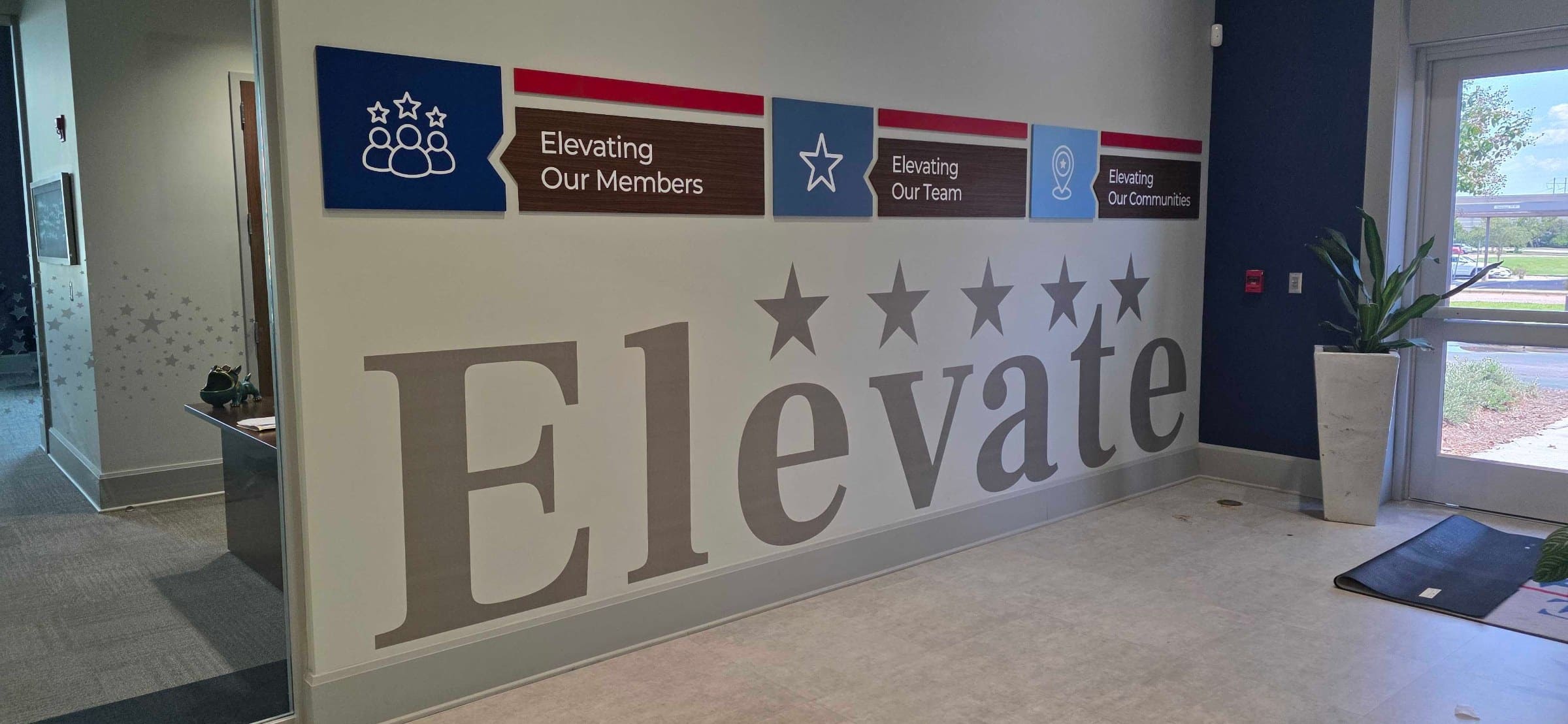 "Elevate" lobby vinyl letters and blue acrylic panels, Five Star Credit Union, Dothan, AL, by High Stakes Creative