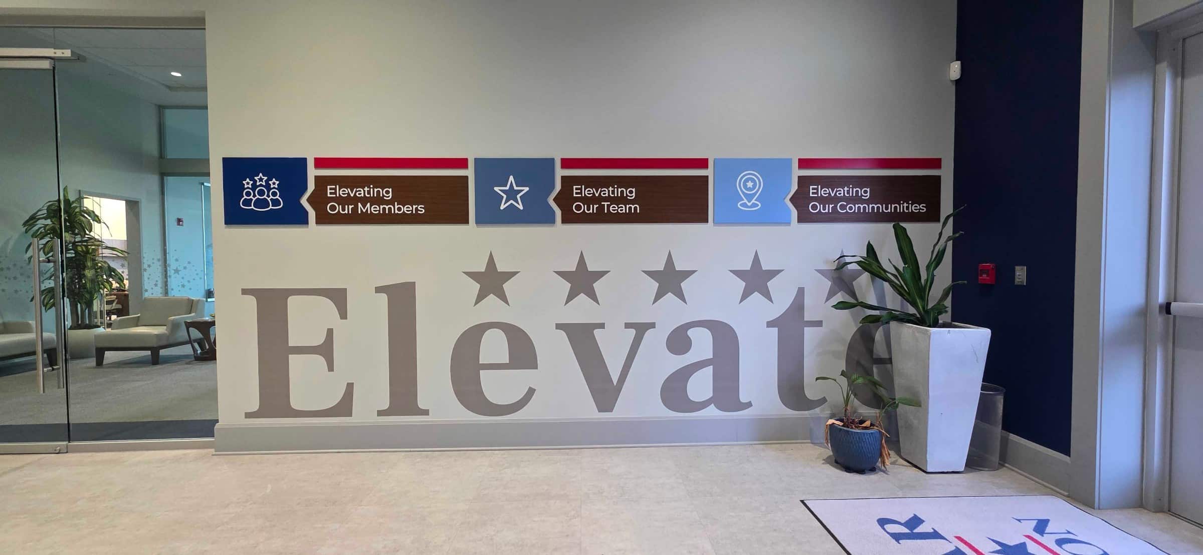 "Elevate" lobby vinyl letters and blue acrylic panels, Five Star Credit Union, Dothan, AL, by High Stakes Creative