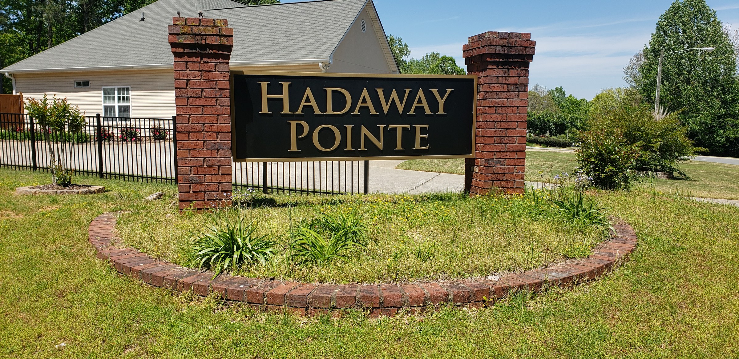 Subdivision entrance sign between brick pillars, Hadaway Pointe, by High Stakes Creative